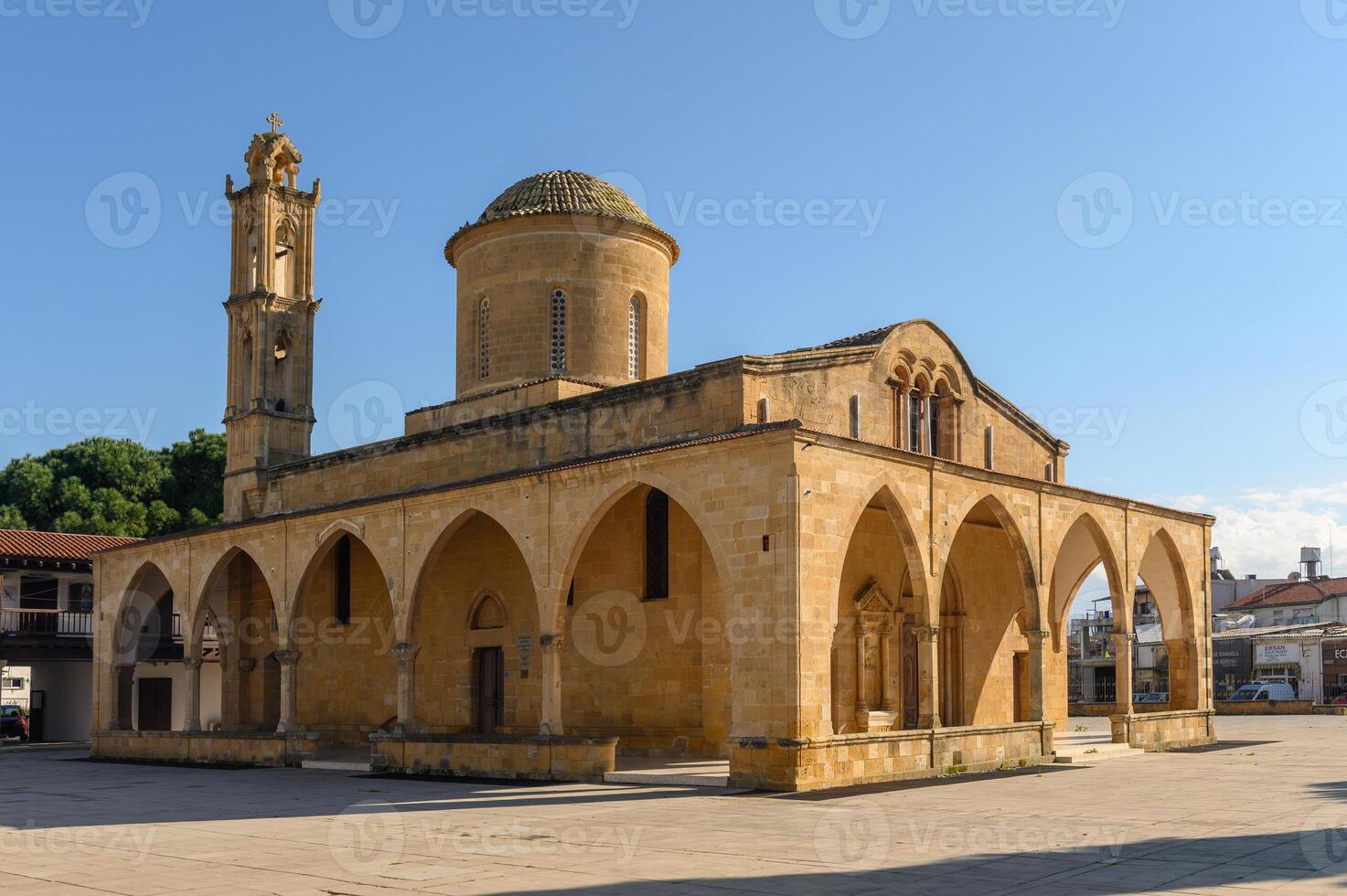 Majestic stone architecture stands in a sunlit plaza surrounded by trees and vibrant buildings photo