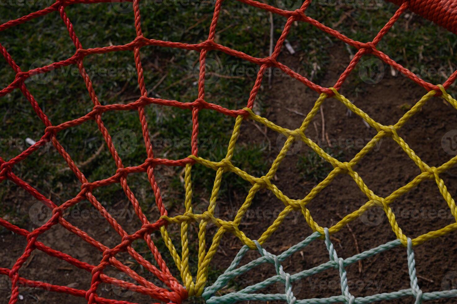 Colorful netting stretches across a grassy field under the afternoon sun photo