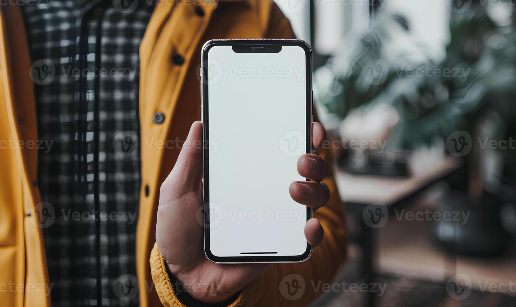 A person holding up a blank white iphone photo