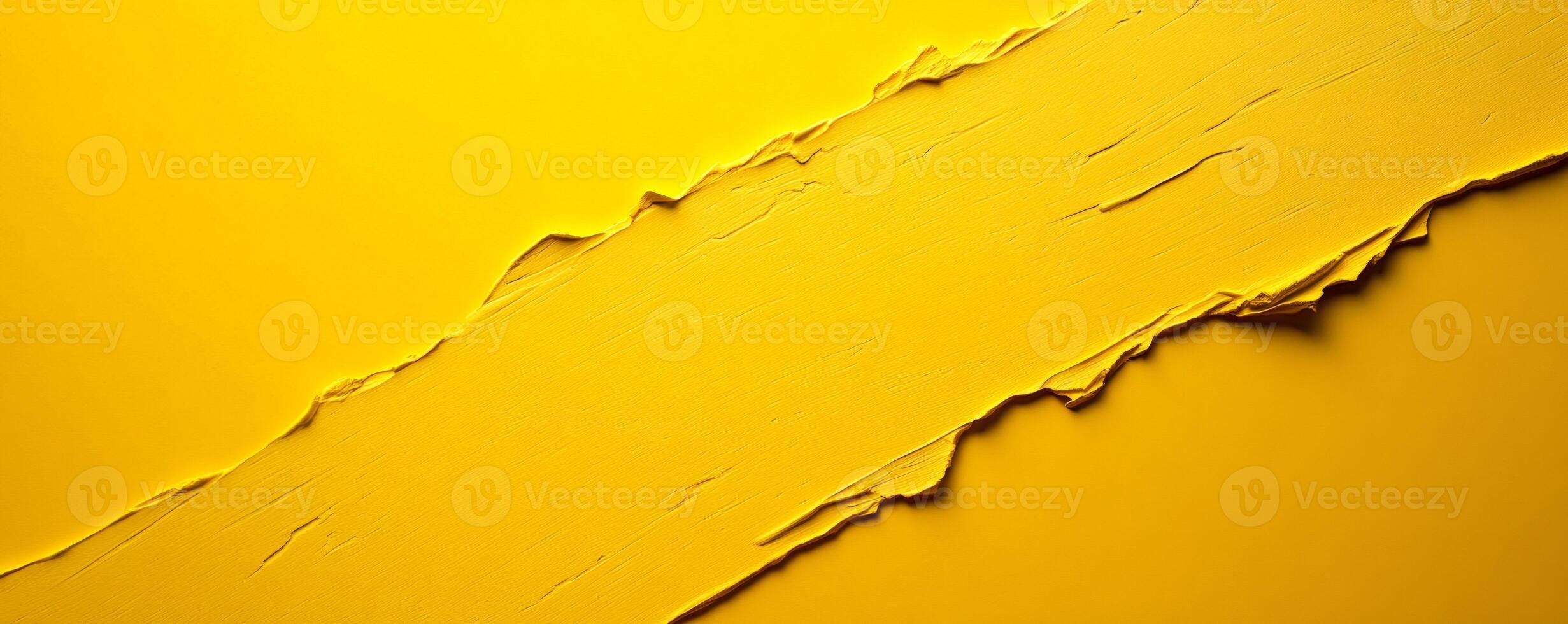 Thick yellow paint is creating a textured diagonal stripe on a yellow background photo
