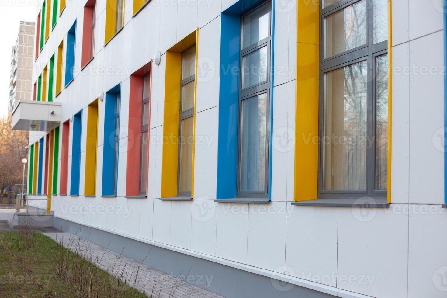Multicolored, large windows of a childcare or hospital building photo