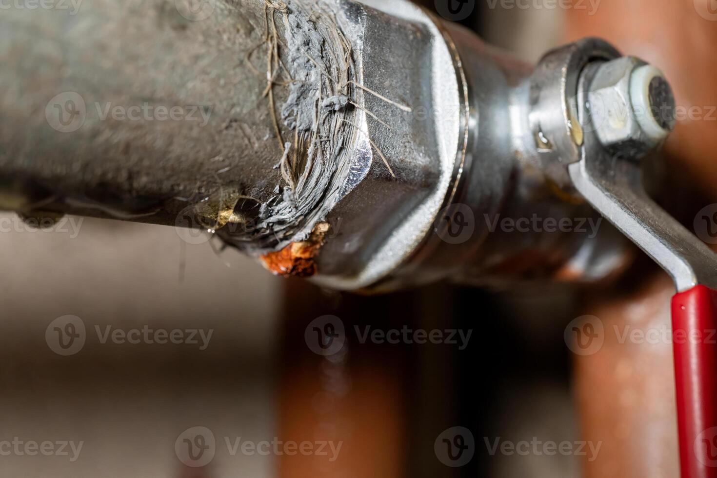 Corroded metal pipe with rust and valve close-up photo