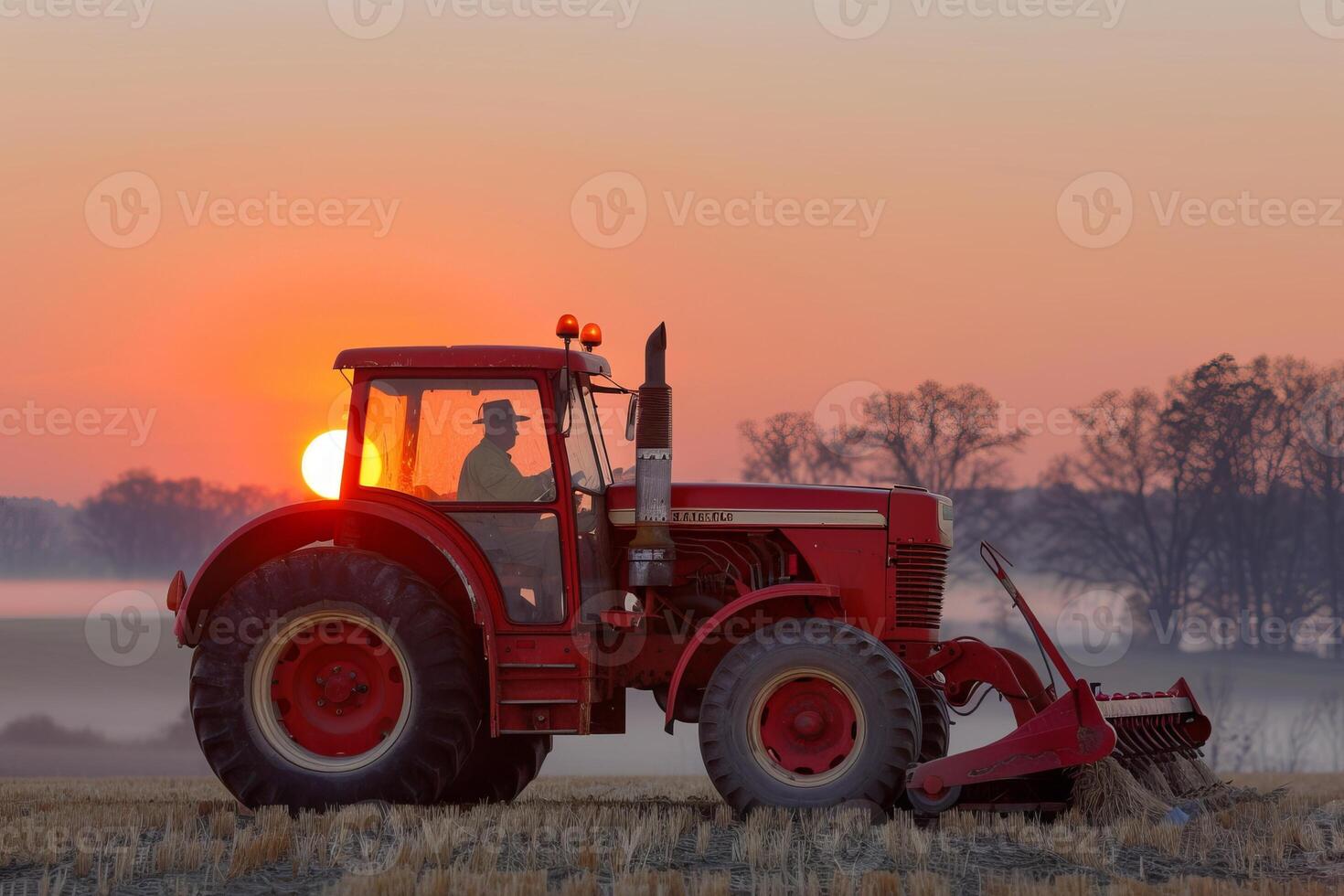 Silhouette of farmer on red tractor at sunset in serene rural landscape photo