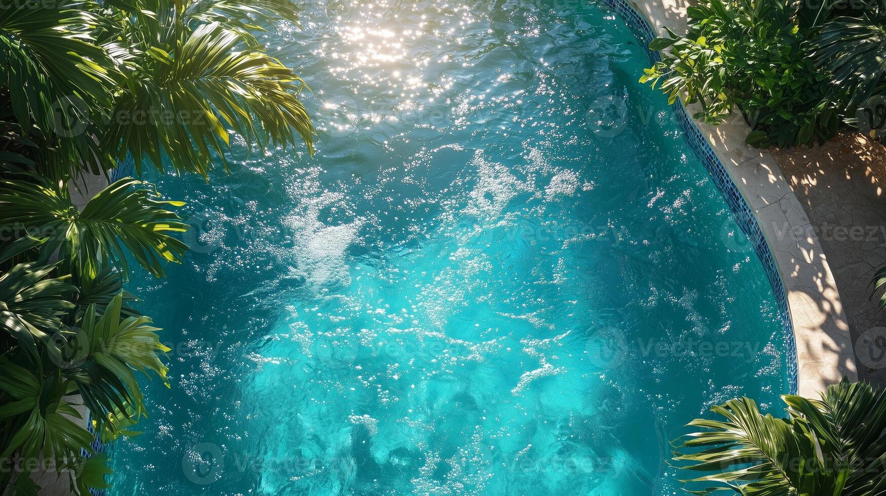 An aerial view of a pool surrounded by palm trees photo