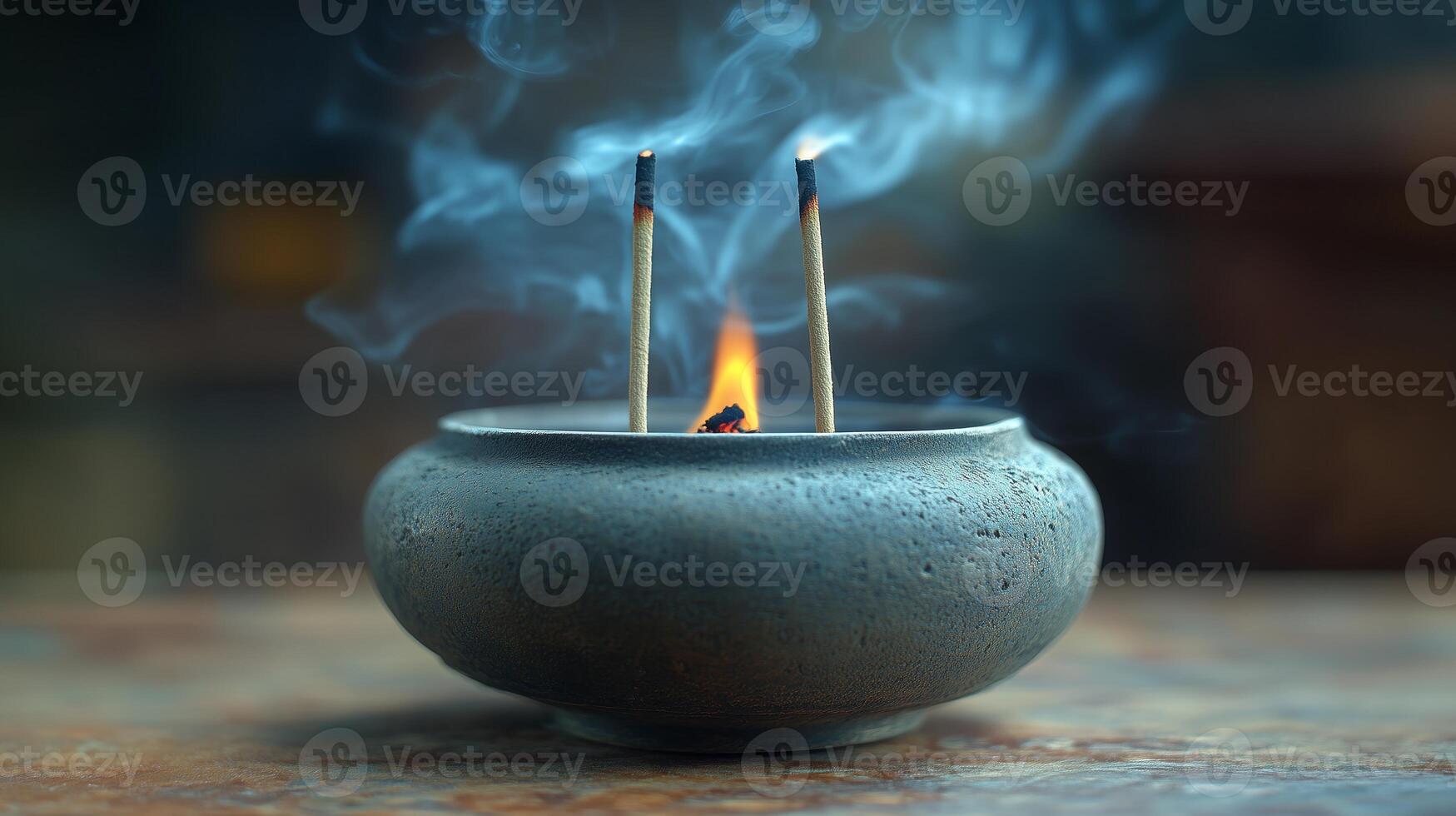 A small bowl with incense sticks burning photo