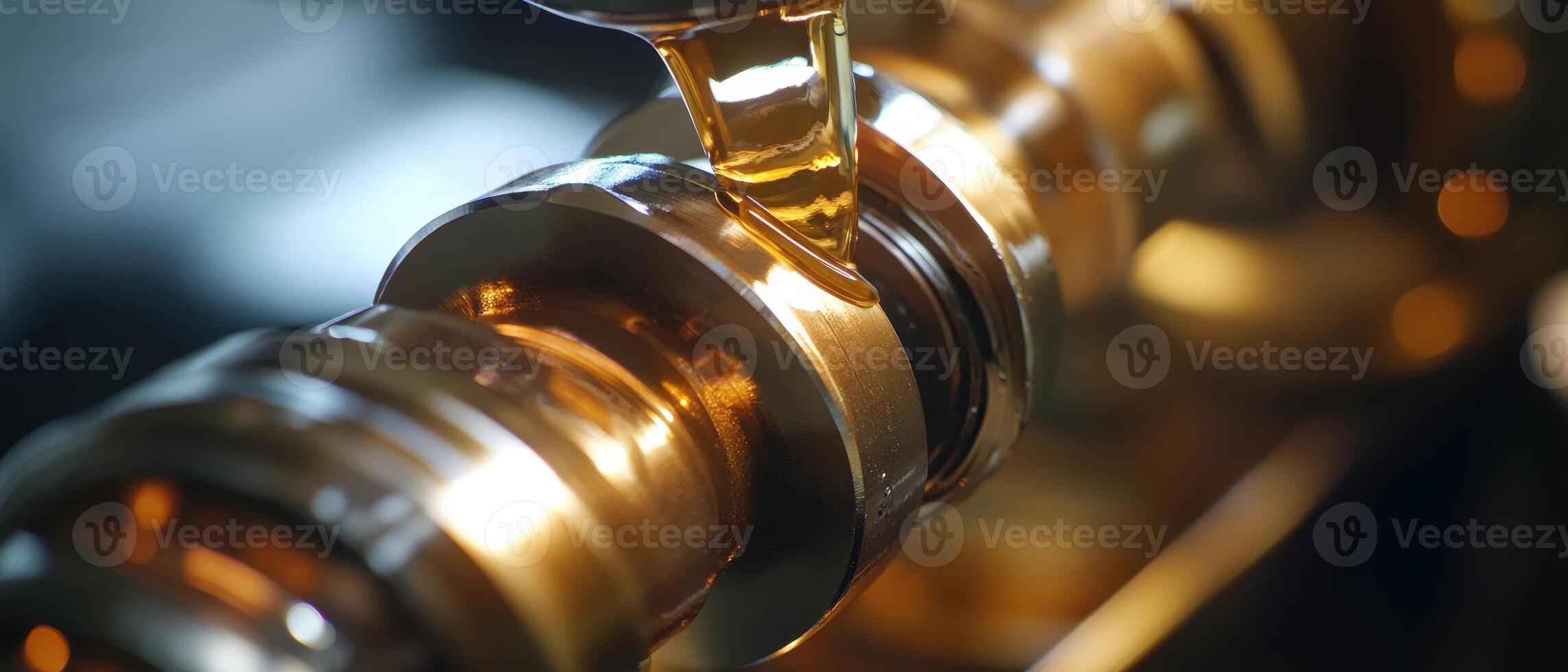 Close-up of a shiny, metallic engine component with oil being applied, highlighting precision engineering and maintenance. photo