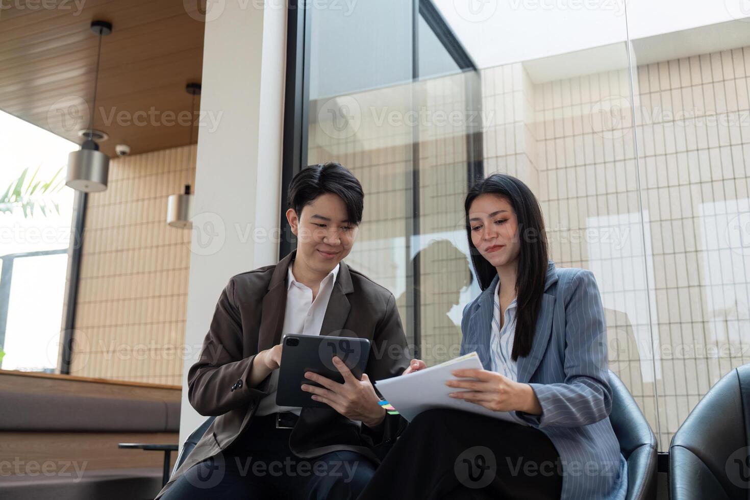 Business team collaborating on project plans and analyzing strategies in a contemporary office space. photo