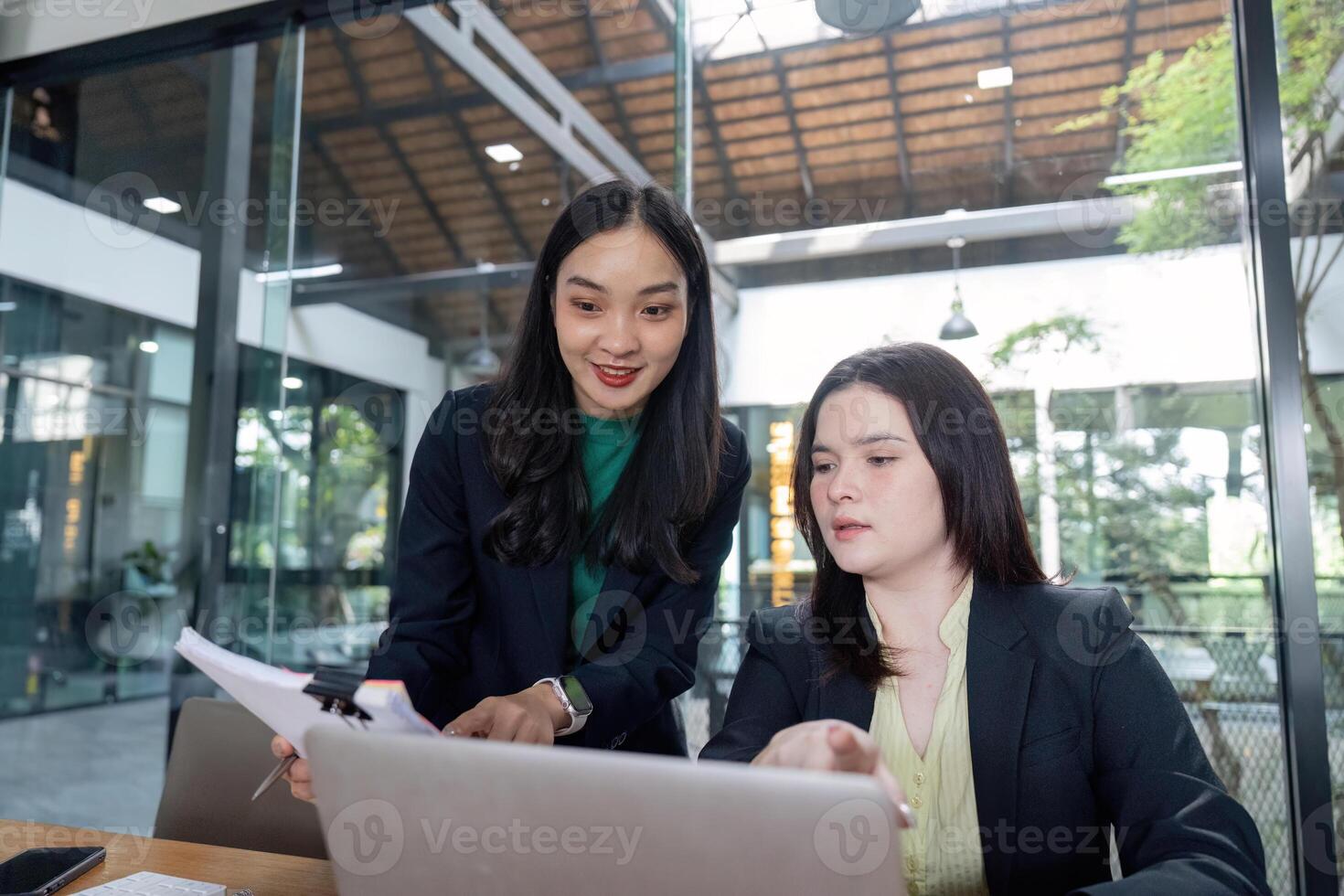 Business team analyzing documents and planning strategies together in a modern office. photo