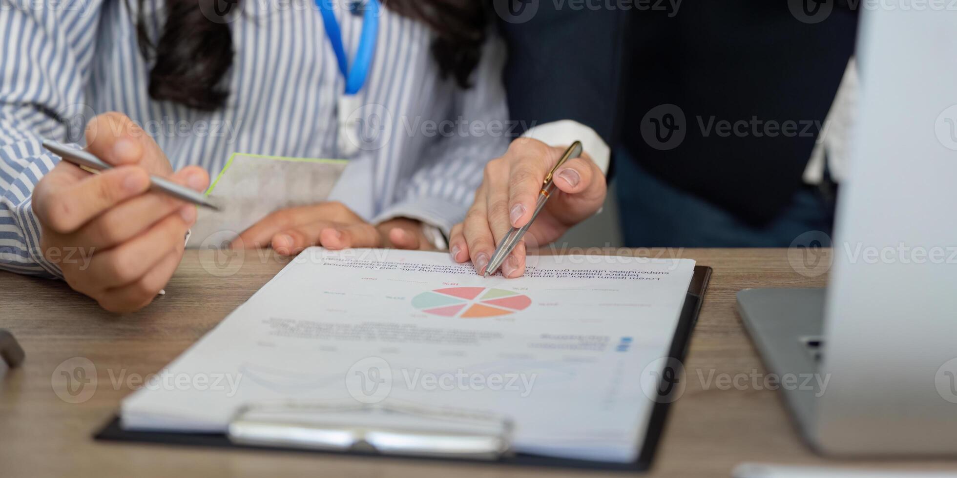 Team collaboration in financial analysis, discussing strategy with charts and notes. photo