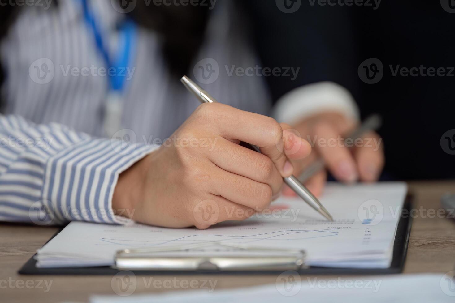 Close-up of hands analyzing financial data, focusing on calculations and strategies. photo