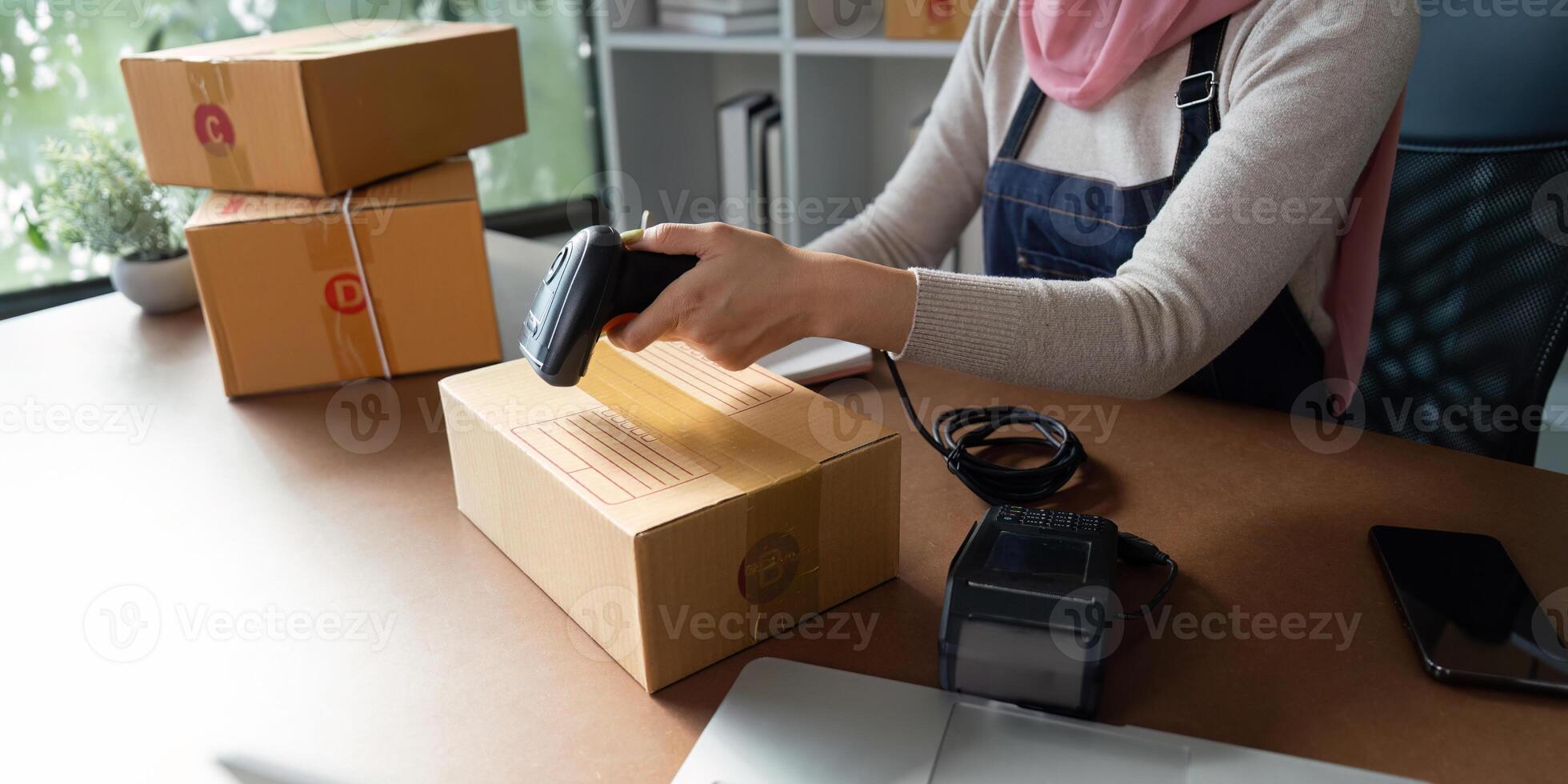 Using a barcode scanner on a package for shipping preparation photo
