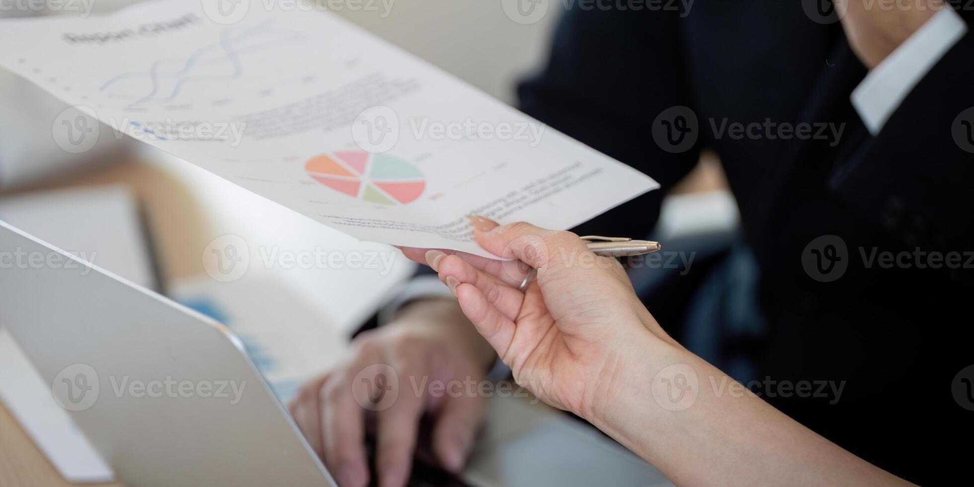 Team member presenting financial reports and graphs during a business meeting. photo