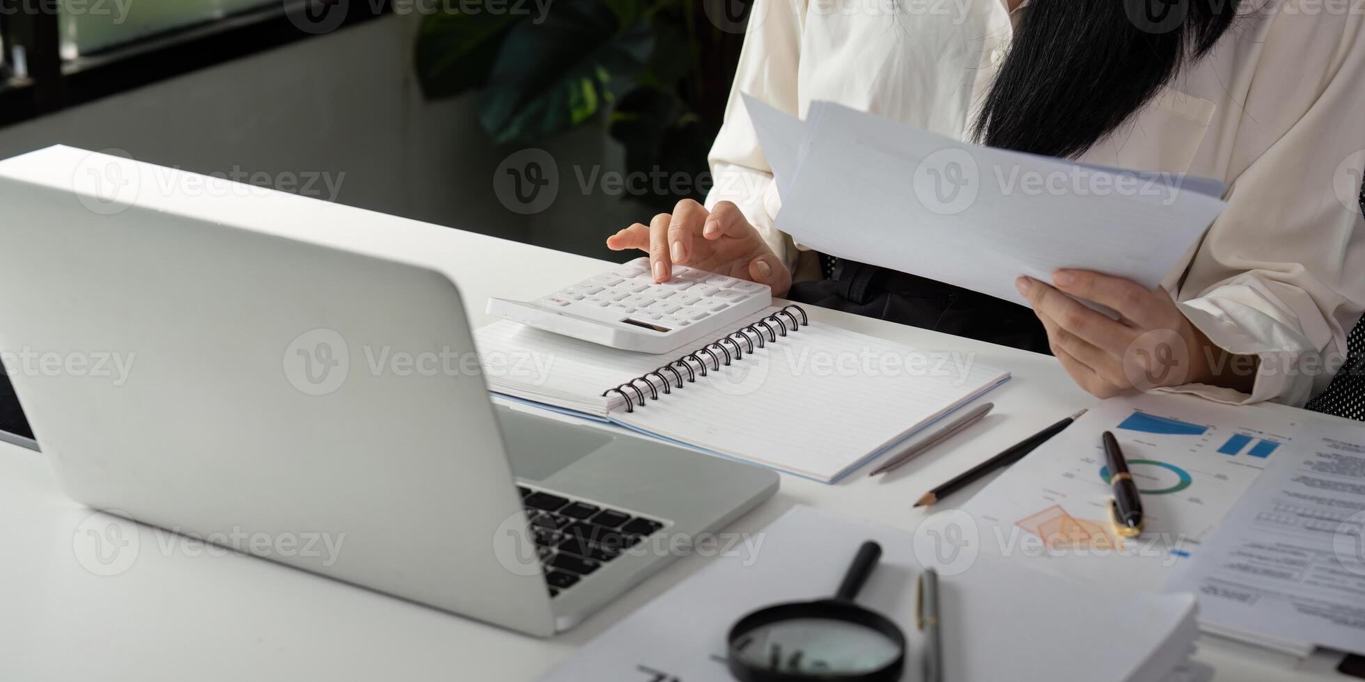 Accountant calculating financial data and preparing reports at a modern office desk. photo