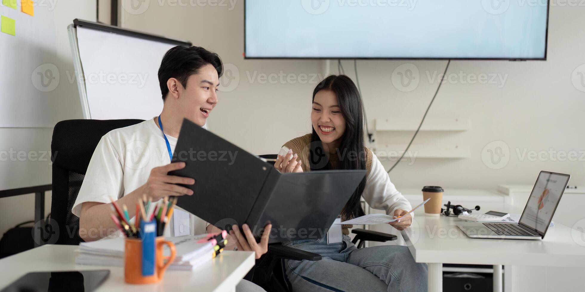 Young professionals collaborating on financial analysis in a modern office setting photo