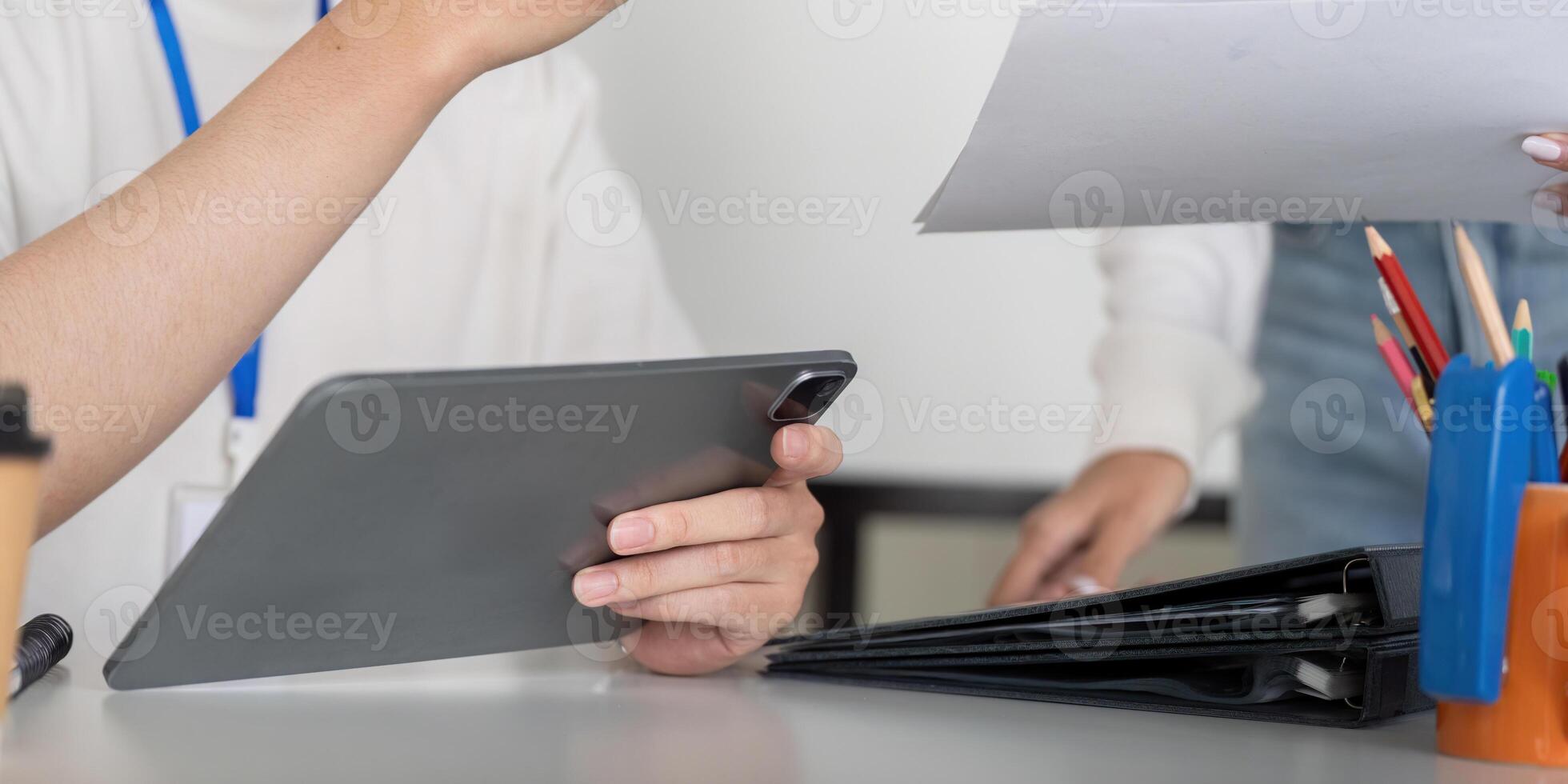 Finance professional using a tablet for tax analysis and document management photo