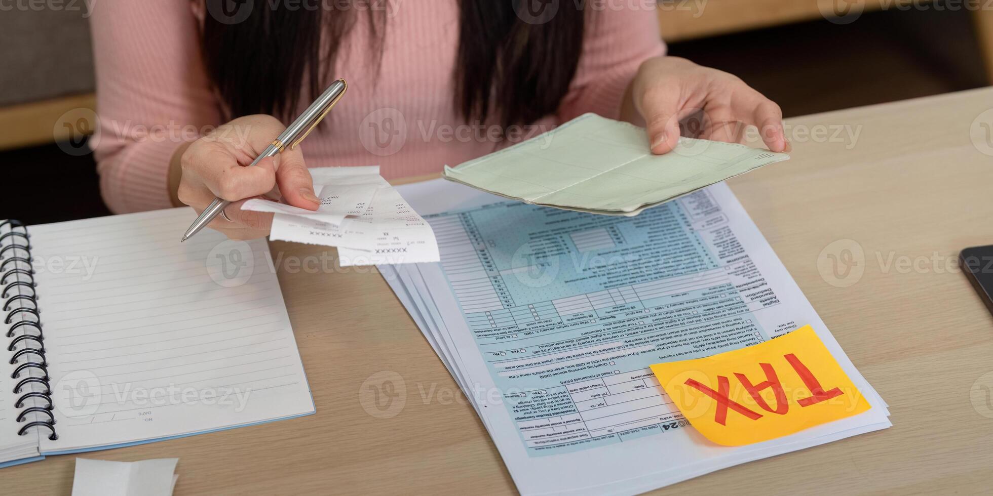 Woman organizing tax documents and receipts for financial planning and strategy. photo