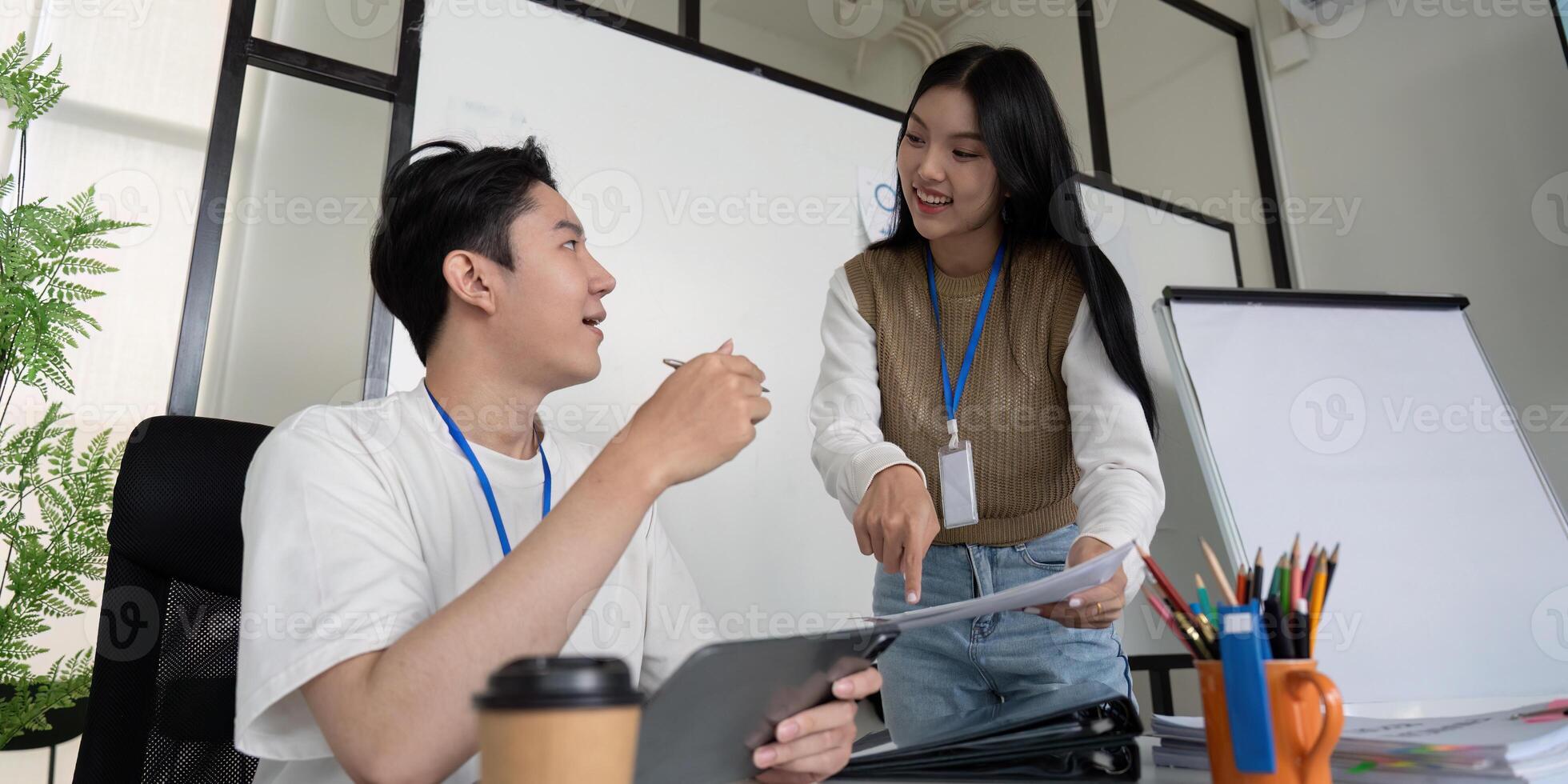 Dynamic discussion between young professionals on financial strategies with documents and a tablet. photo