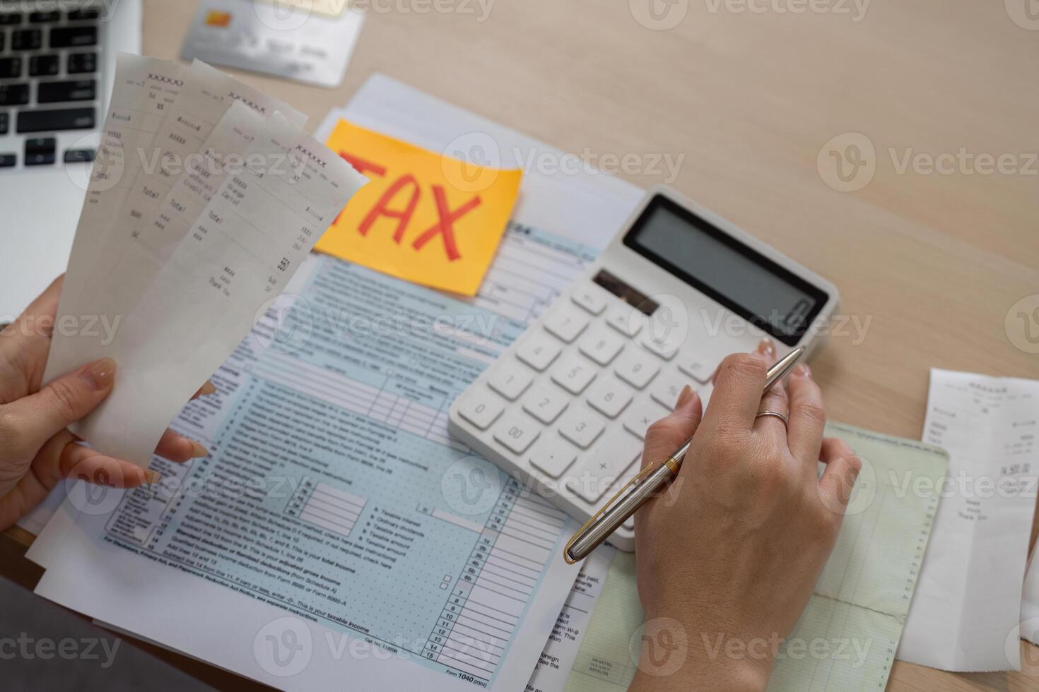 Woman calculating taxes with receipts and a calculator for financial management. photo