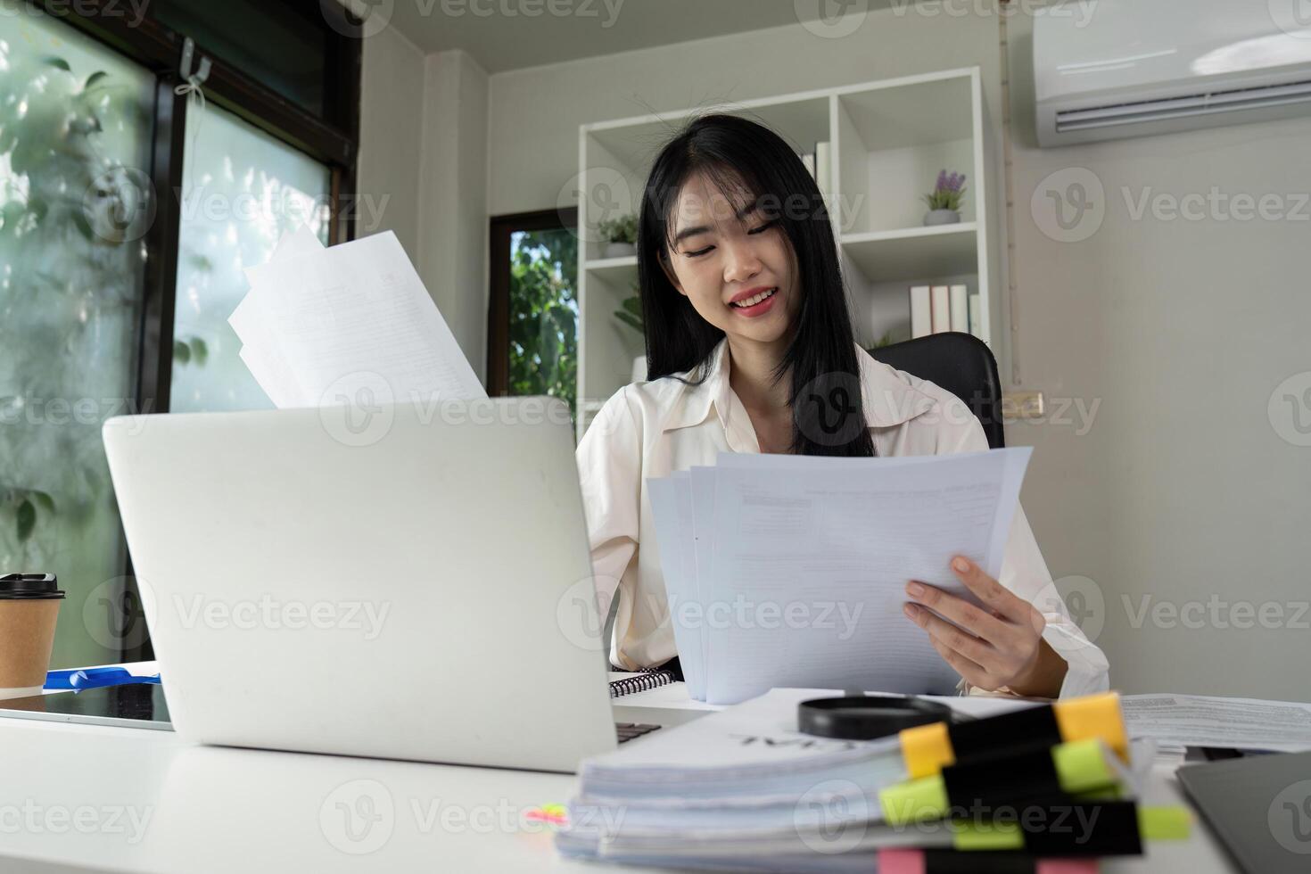 Focused accountant analyzing financial statements and preparing for tax filing at a desk. photo