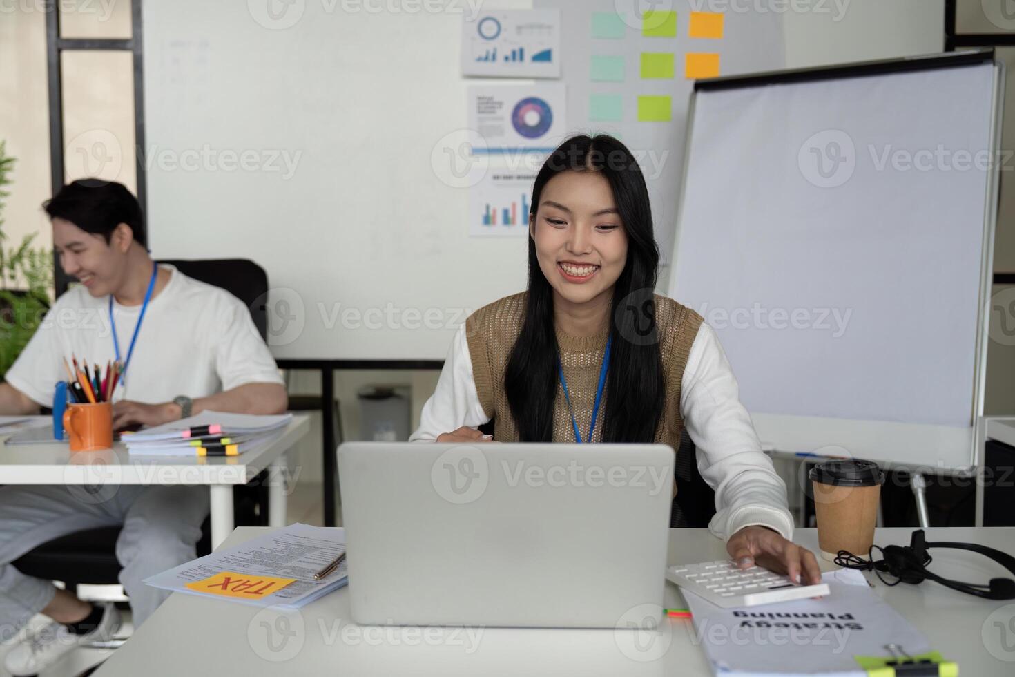 Young professional analyzing tax refund data on a laptop in a modern office setting. photo