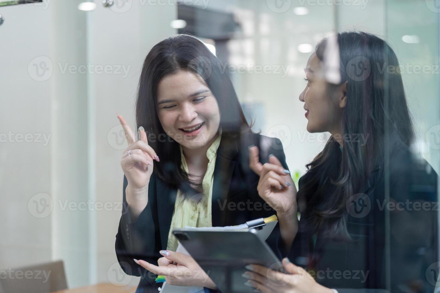 Two professionals discussing financial strategies in a modern office setting. photo