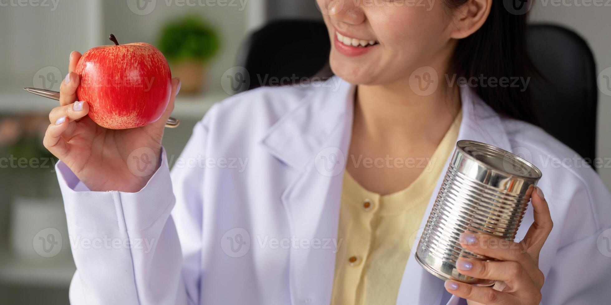 Nutritionist holding an apple and a pen, discussing healthy eating habits. photo