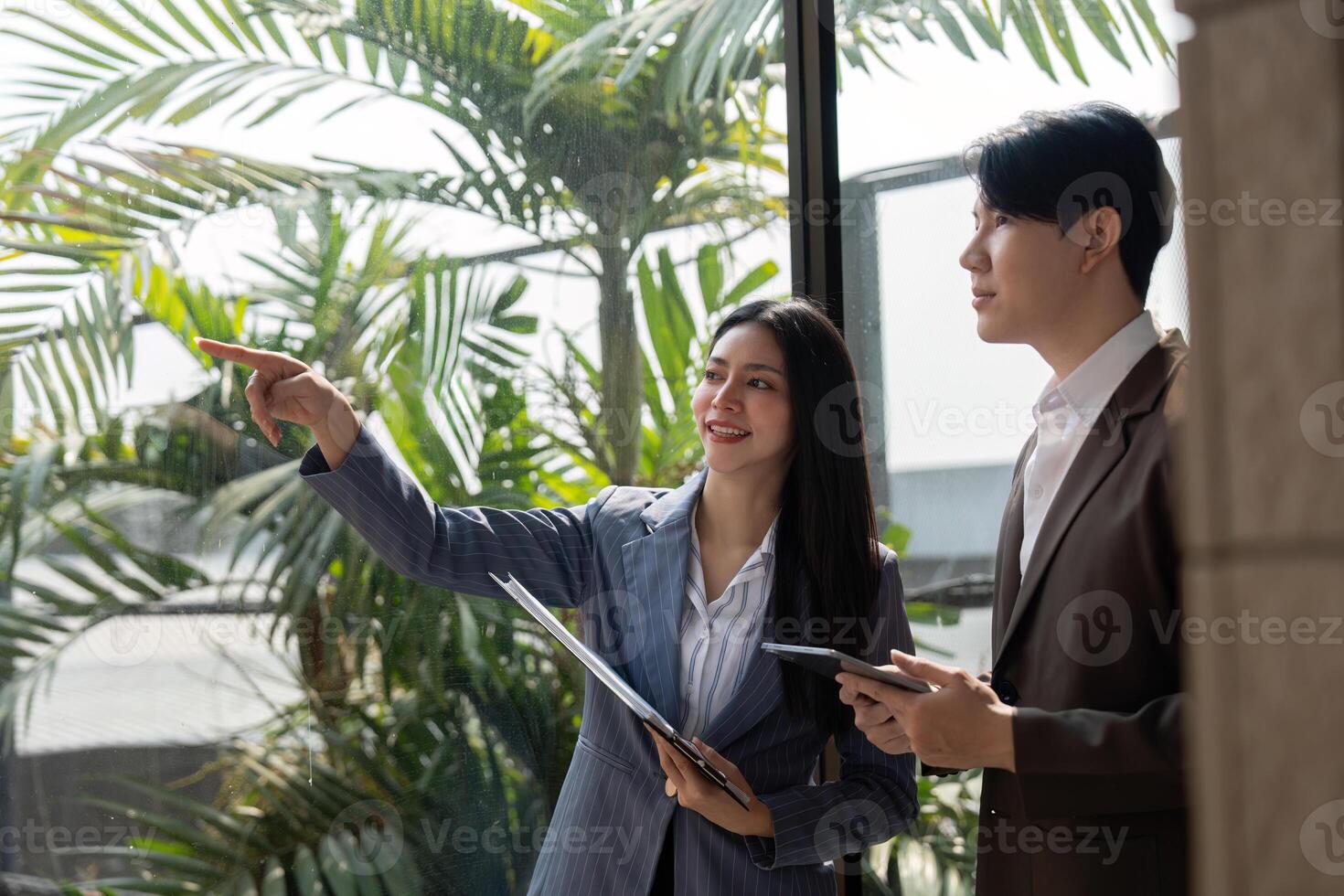 Team members discussing and analyzing ideas with sticky notes and charts in a modern office. photo