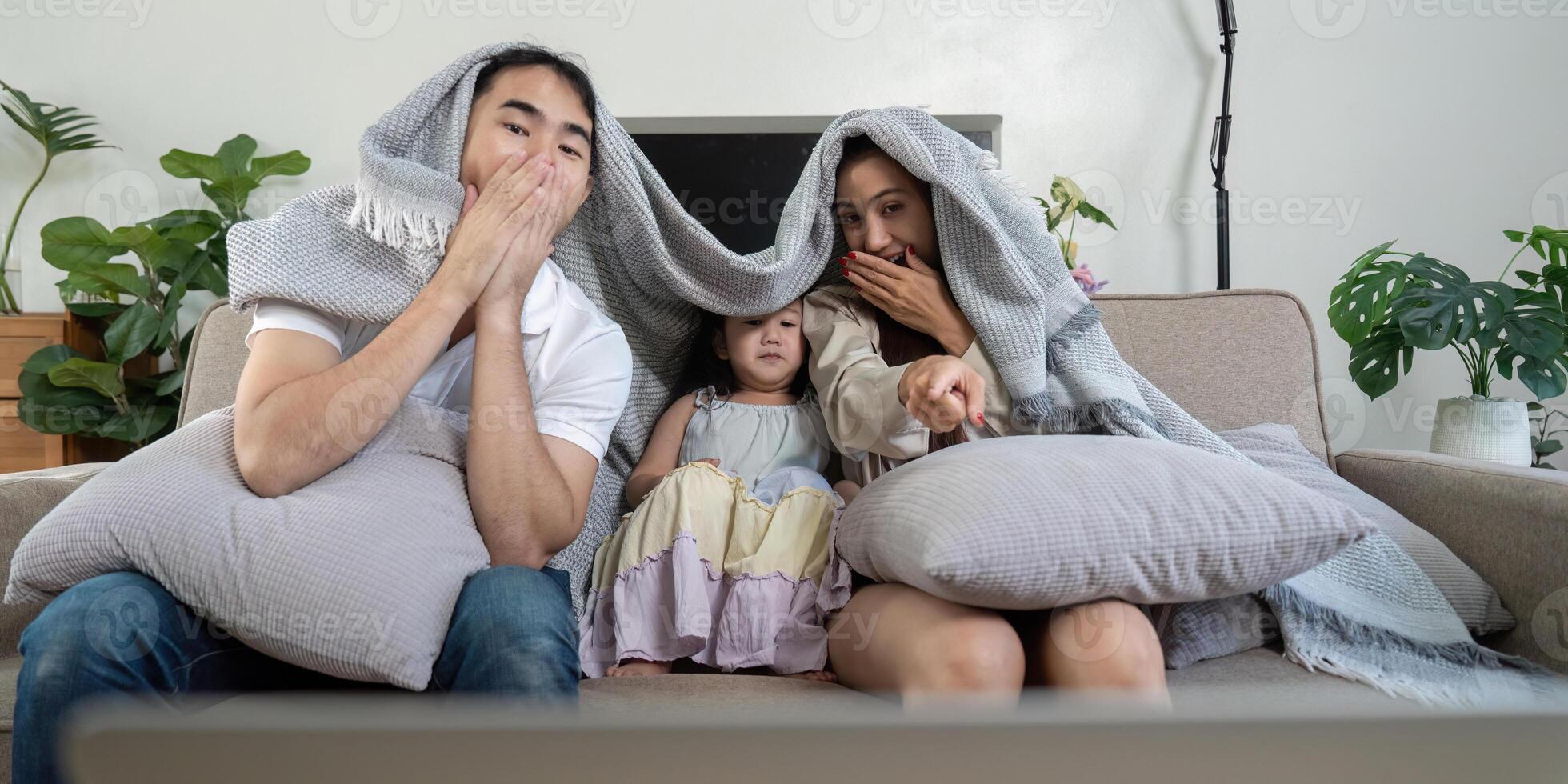 Family enjoying movie time together with popcorn and a laptop photo