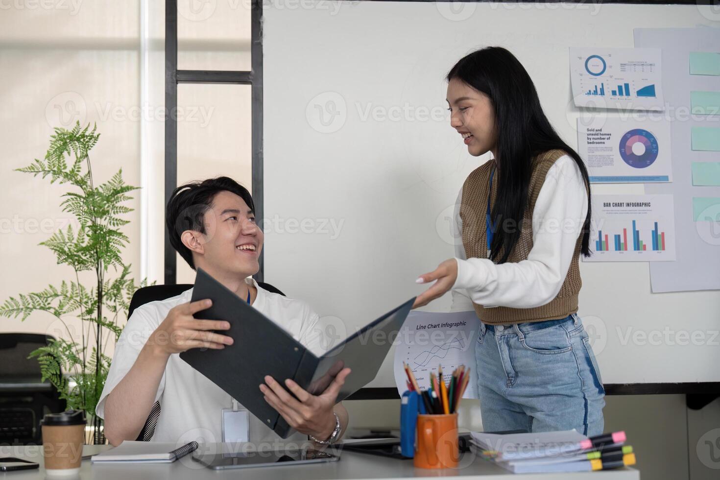 Young professionals reviewing financial reports and collaborating on strategies in a modern office. photo