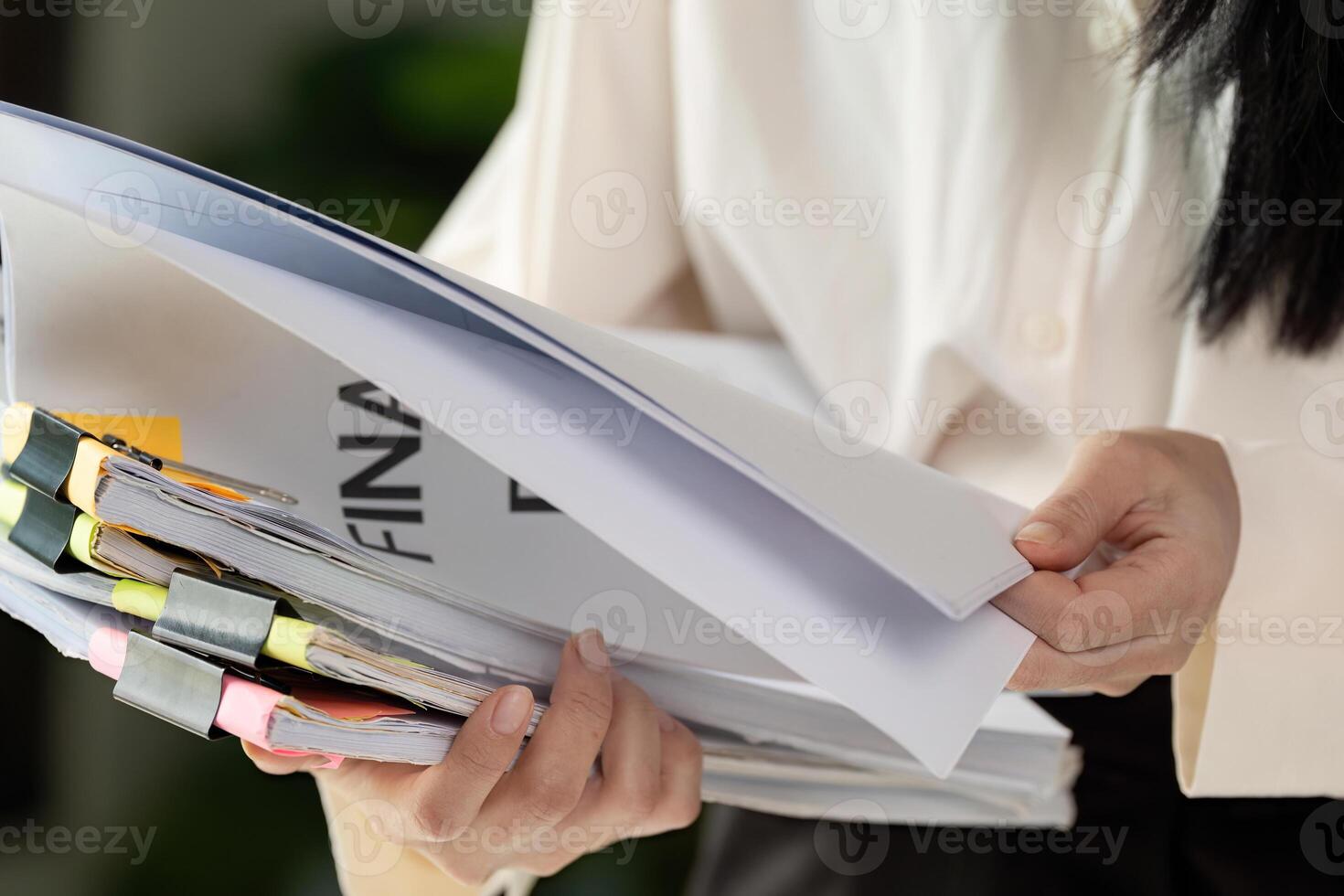 Tax organization. A young woman holding carefully organized tax files in her hands. photo