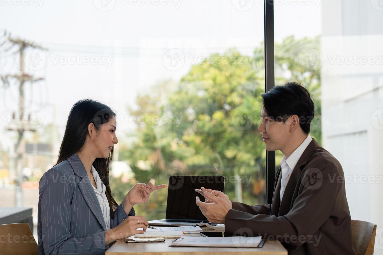 Collaboration in planning. Two professionals discussing project strategies in a modern workspace. photo