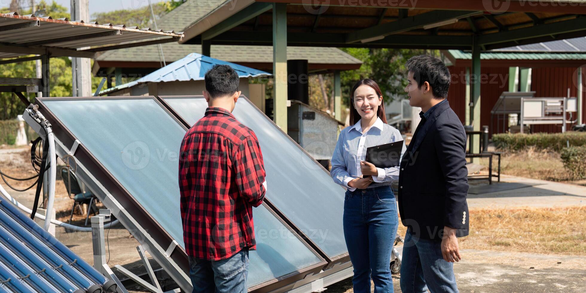 Collaboration in solar energy inspection. Team members evaluating solar panel technology and discussing sustainable solutions. photo