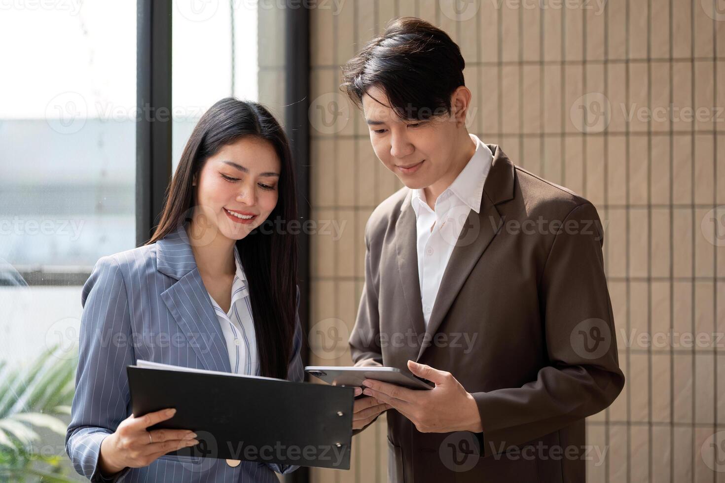 Engaged teamwork. Business professionals reviewing project documentation and digital data in a modern office setting. photo