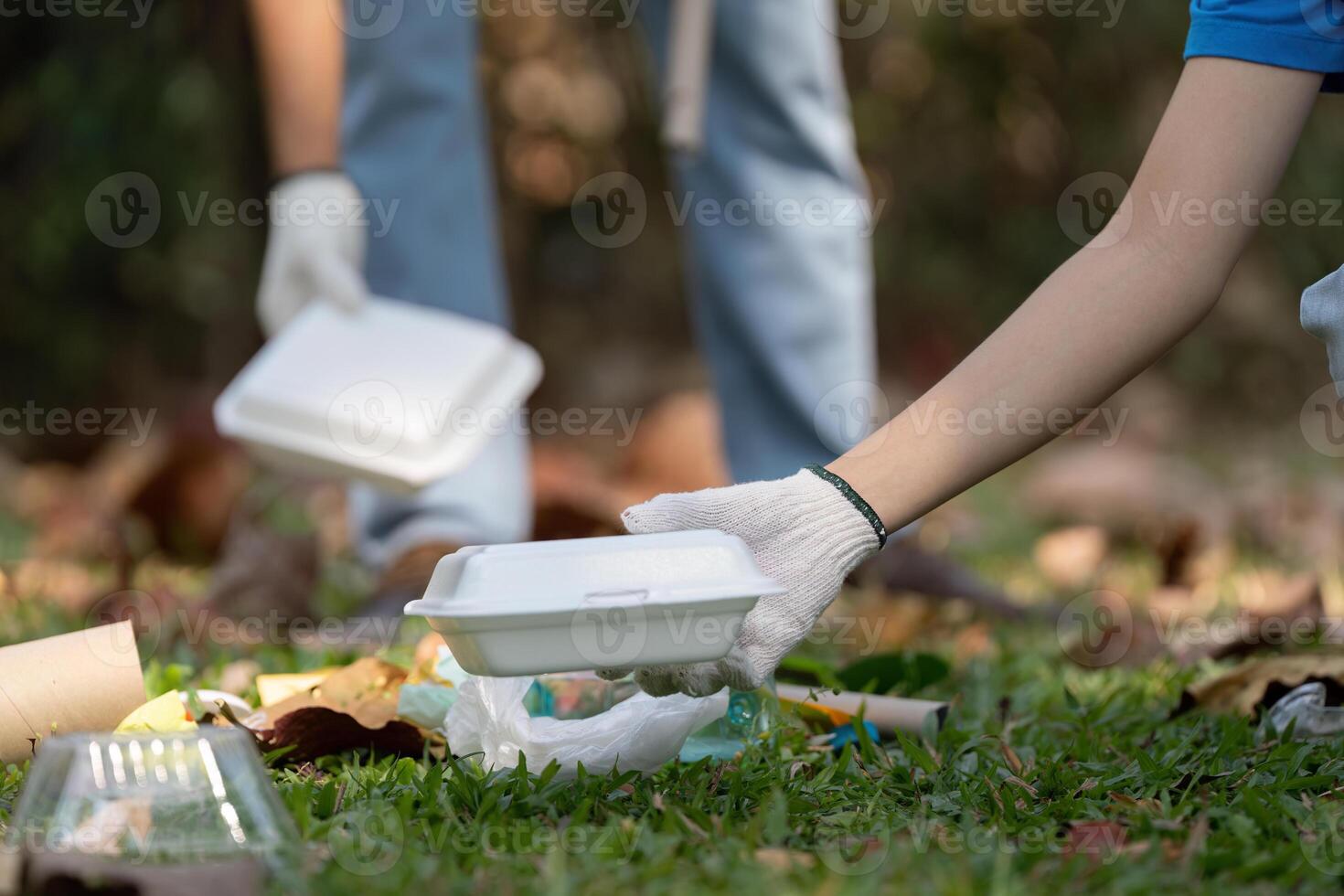 Volunteer picking up trash during a community cleanup event photo