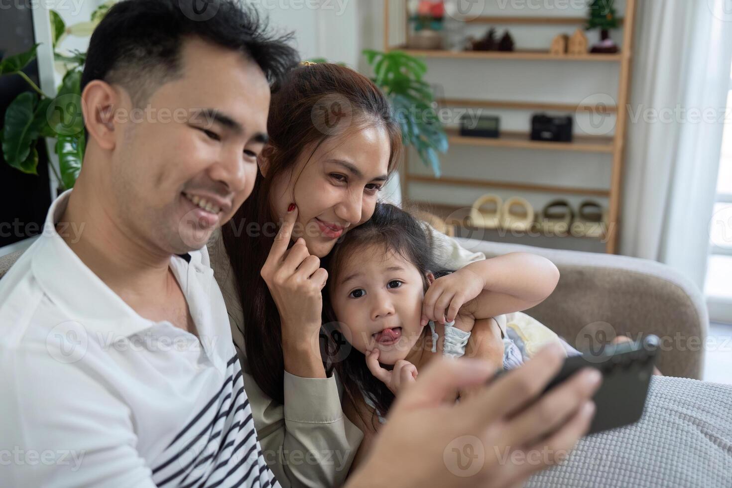 Playful family enjoying fun moments together with a smartphone photo