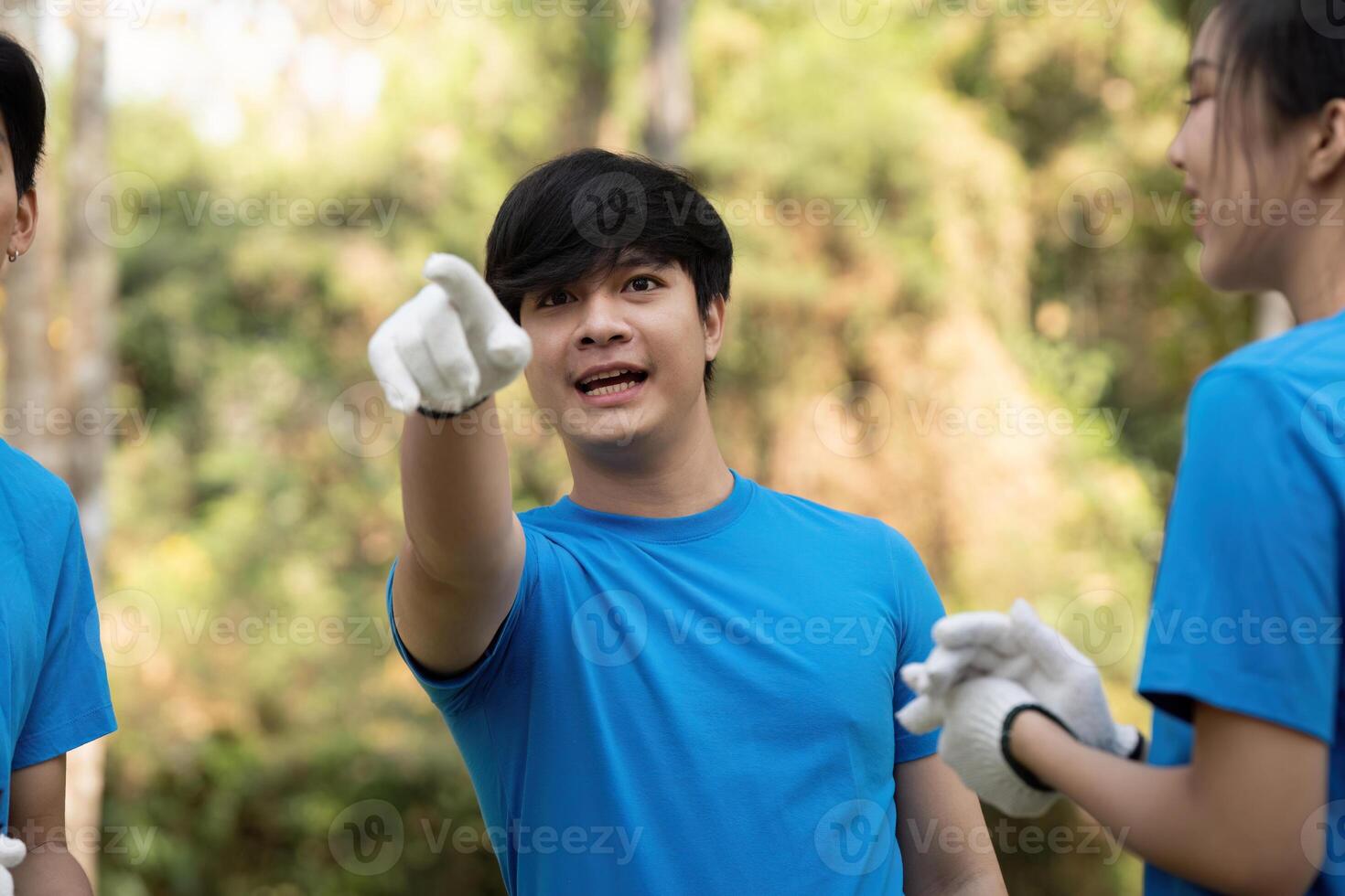 Volunteer pointing and directing efforts during a community clean-up, fostering teamwork and engagement. photo