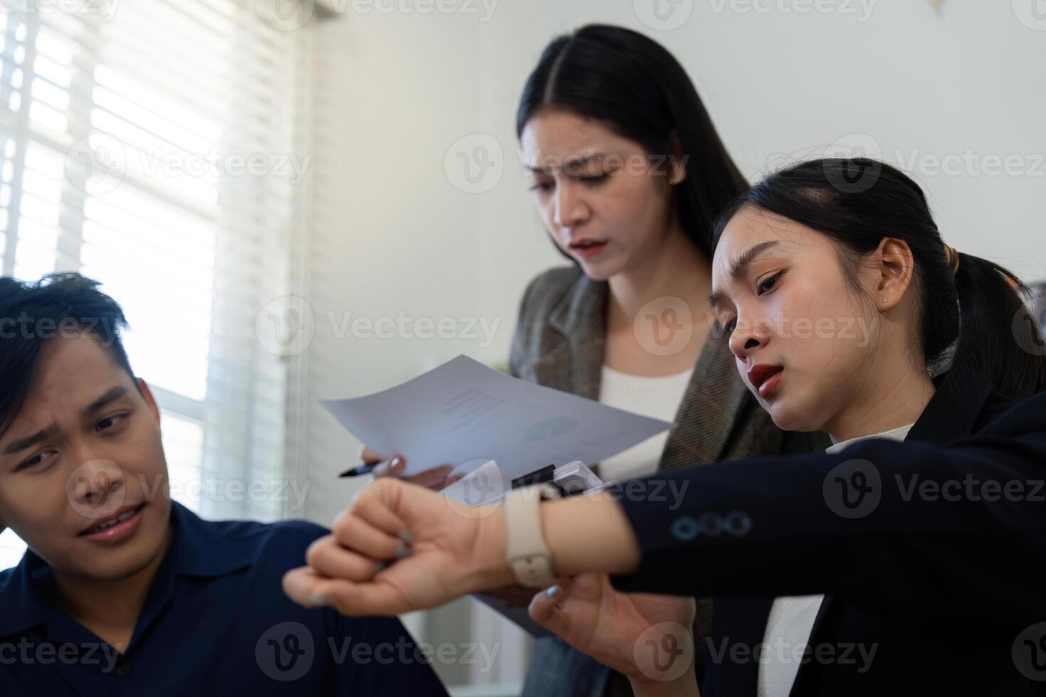 Team members reviewing time-sensitive documents in a high-pressure situation. photo