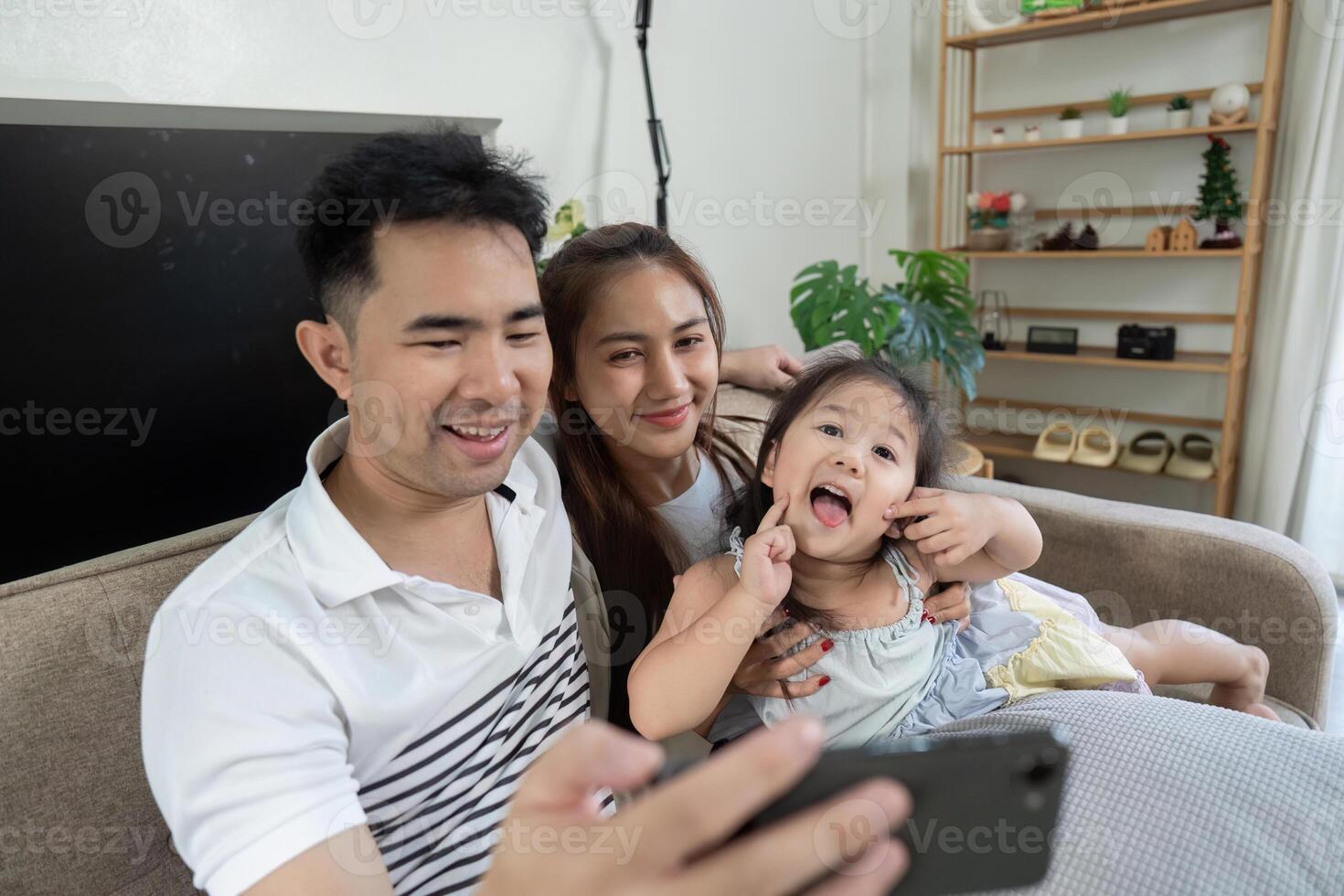 Cheerful family capturing memories together with a smartphone photo