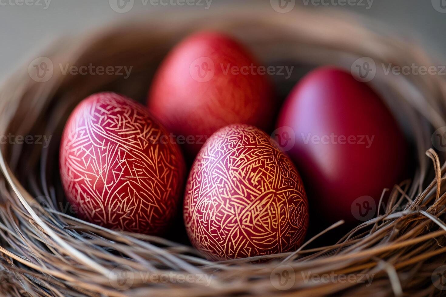 Traditional red easter eggs with folk decoration lying in a nest photo