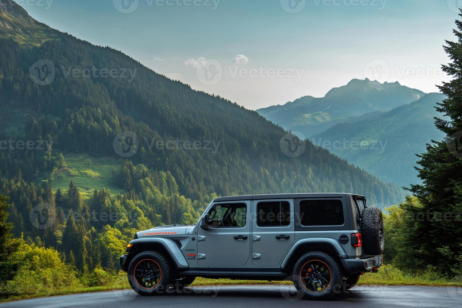 Jeep Wrangler Rubicon 4x4 parked on a mountain road overlooking a valley photo