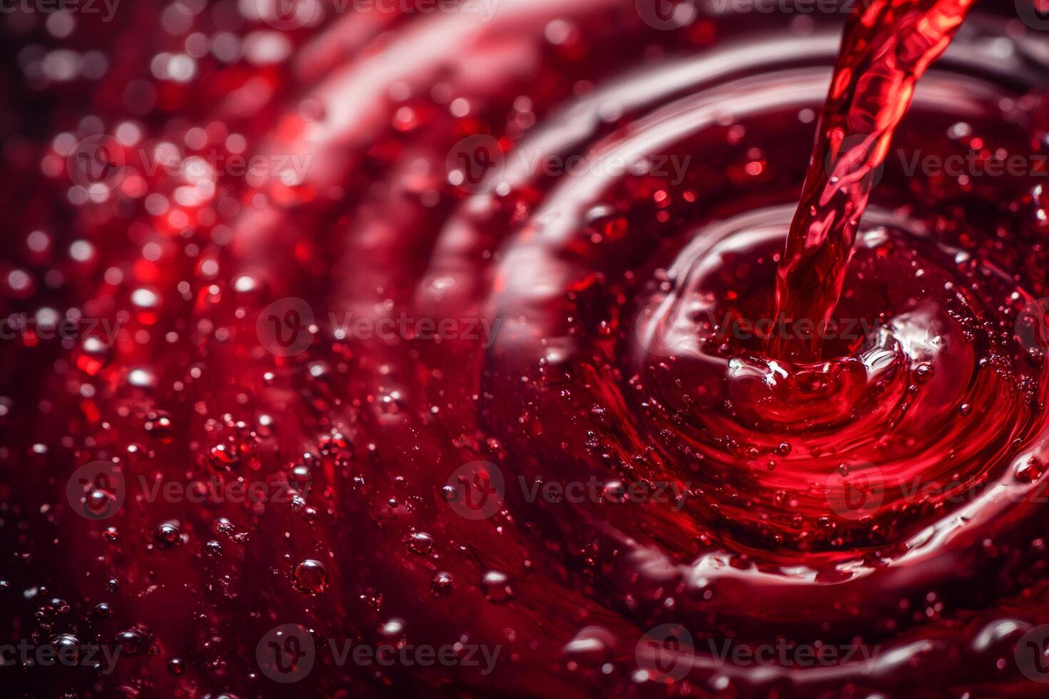 Stream of red liquid creating ripples and bubbles photo
