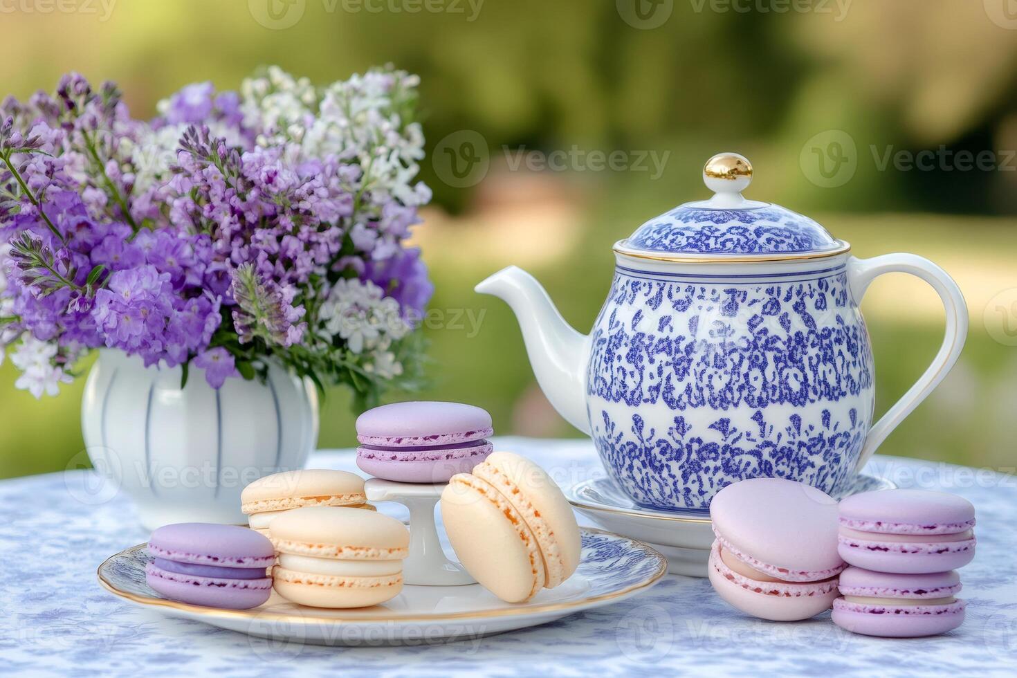 Delicious macarons and elegant teapot enjoying a spring afternoon photo
