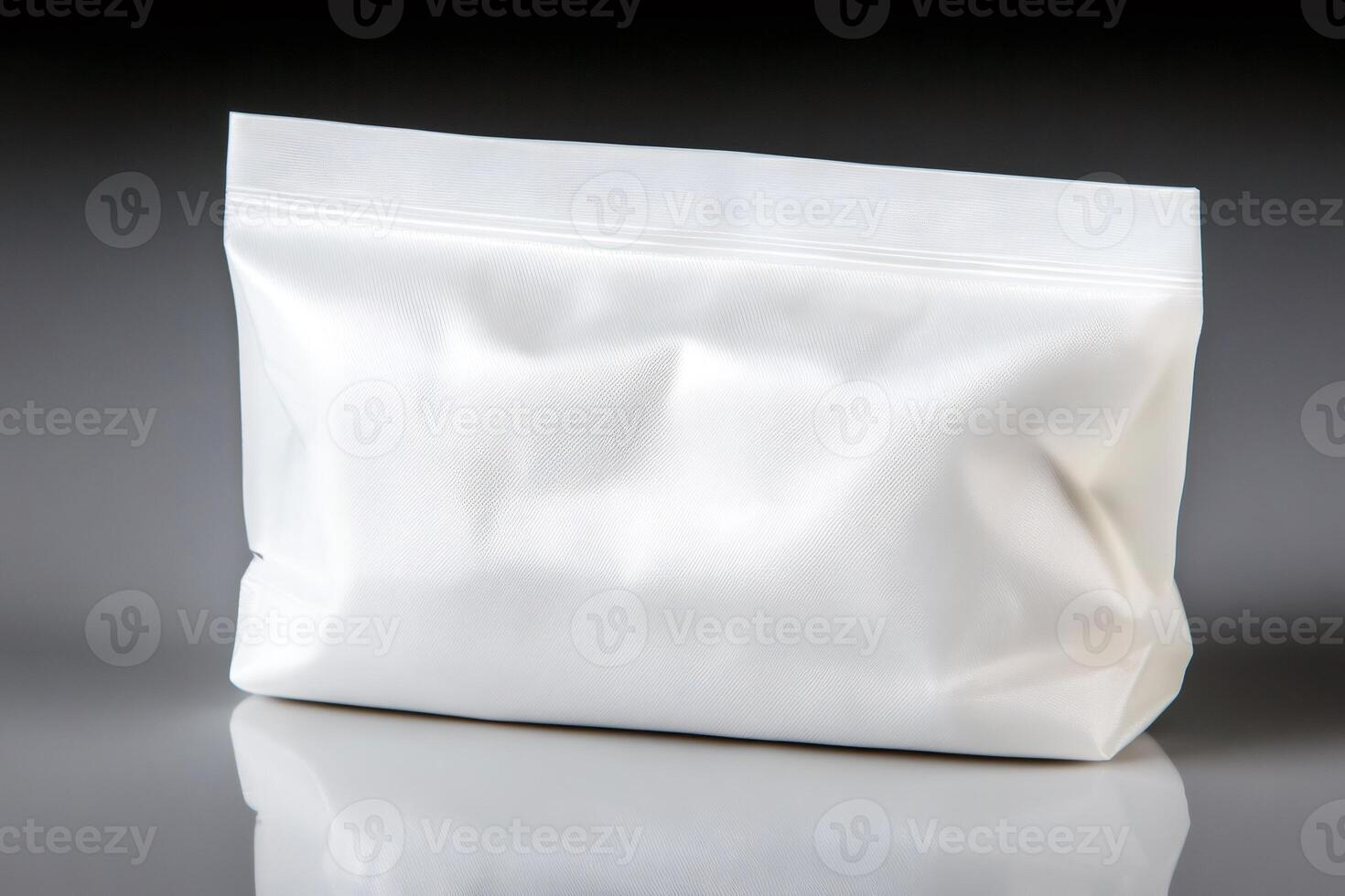 White plastic zipper storage bag on reflective surface photo