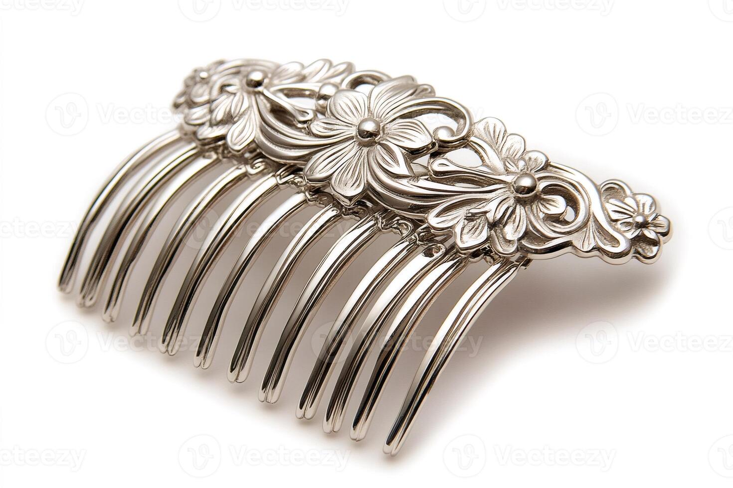 Silver metal hair comb with floral decoration is lying on white background photo