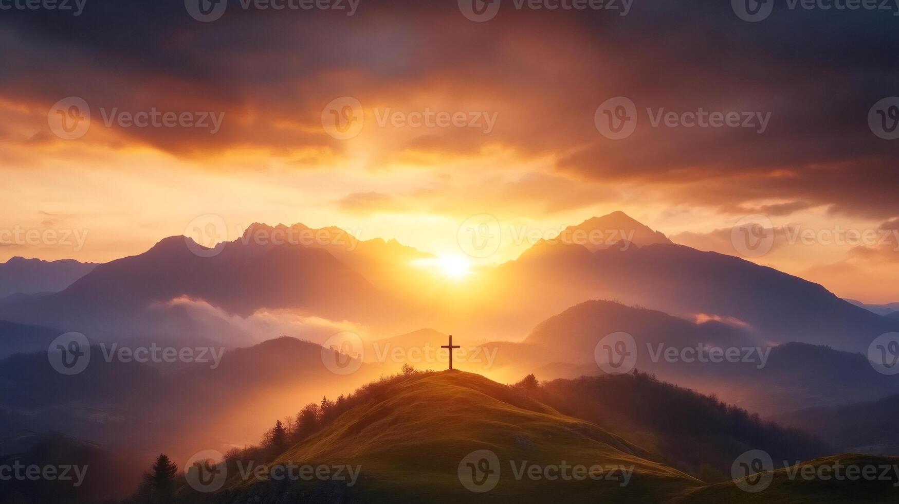 Bright sunrise illuminating cross on grassy hilltop in mountain landscape photo