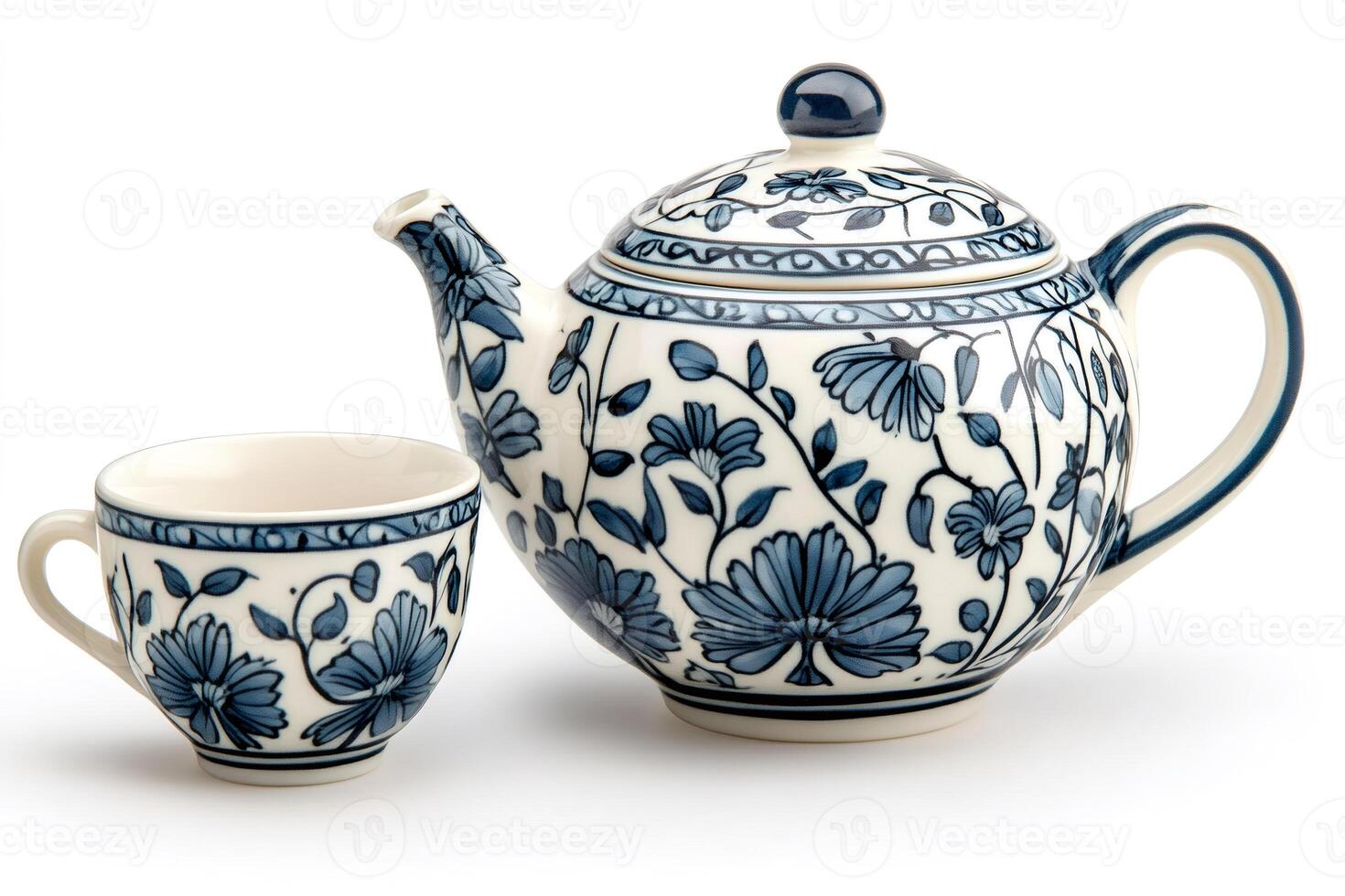 Blue floral pattern adorns a ceramic teapot and teacup, ready for a peaceful tea time photo