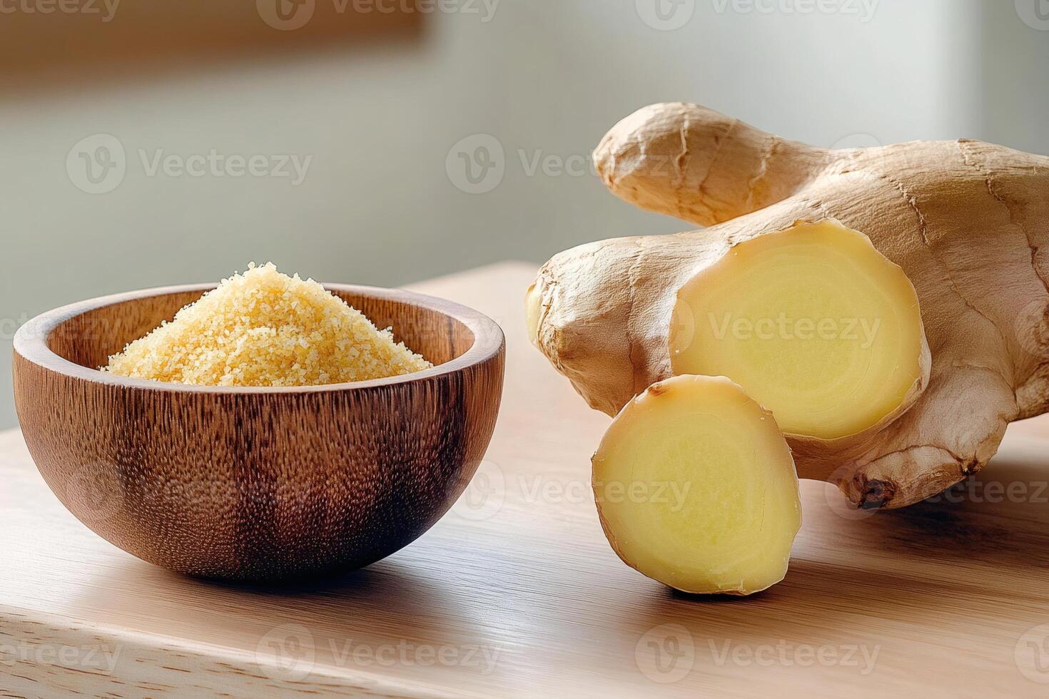 Ground ginger in wooden bowl and fresh ginger root on wooden table photo