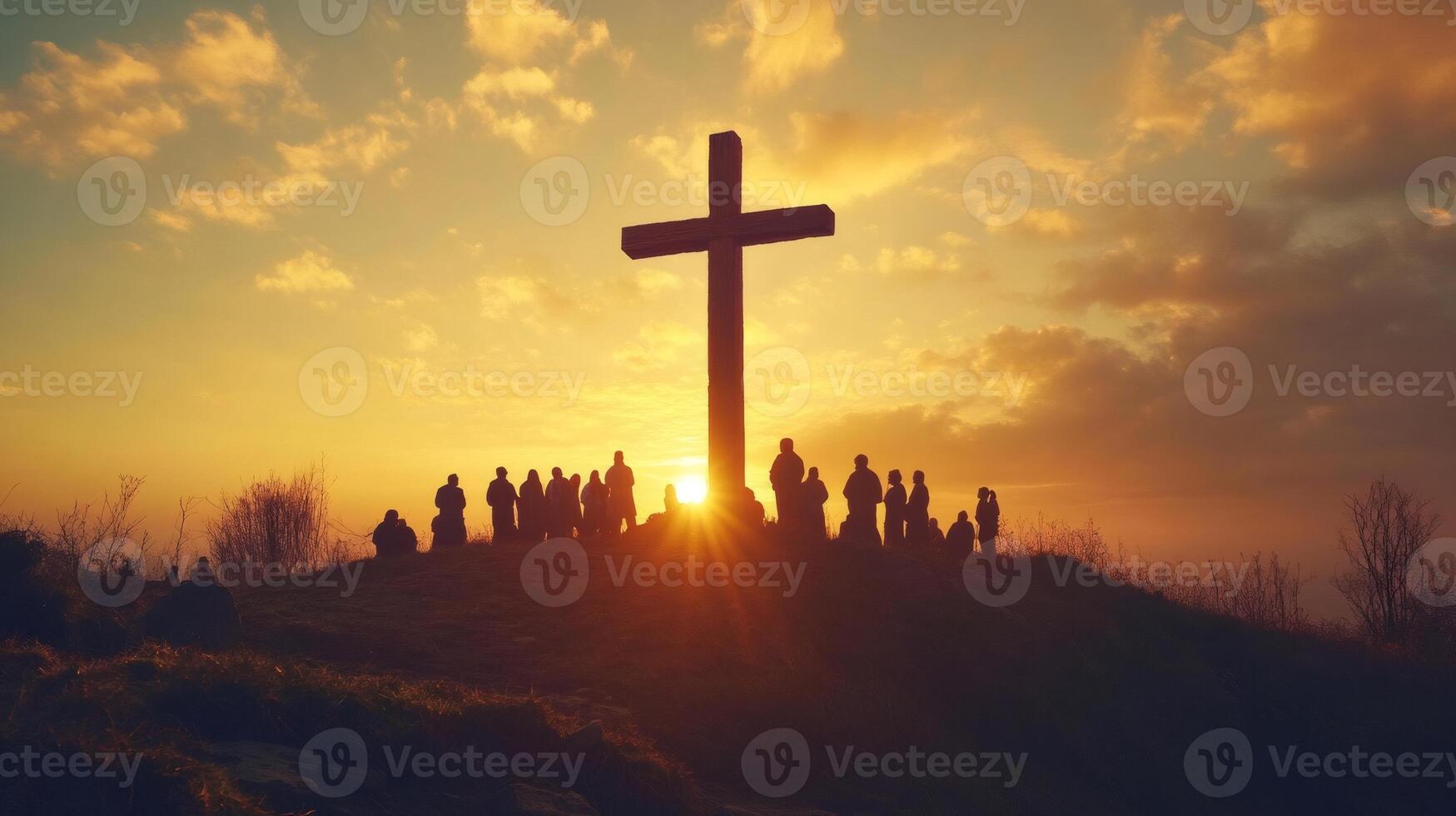Group of believers gathering near a large cross at sunrise photo