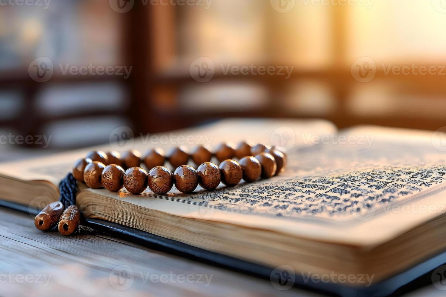 Prayer beads resting on open religious book illuminated by sunlight photo