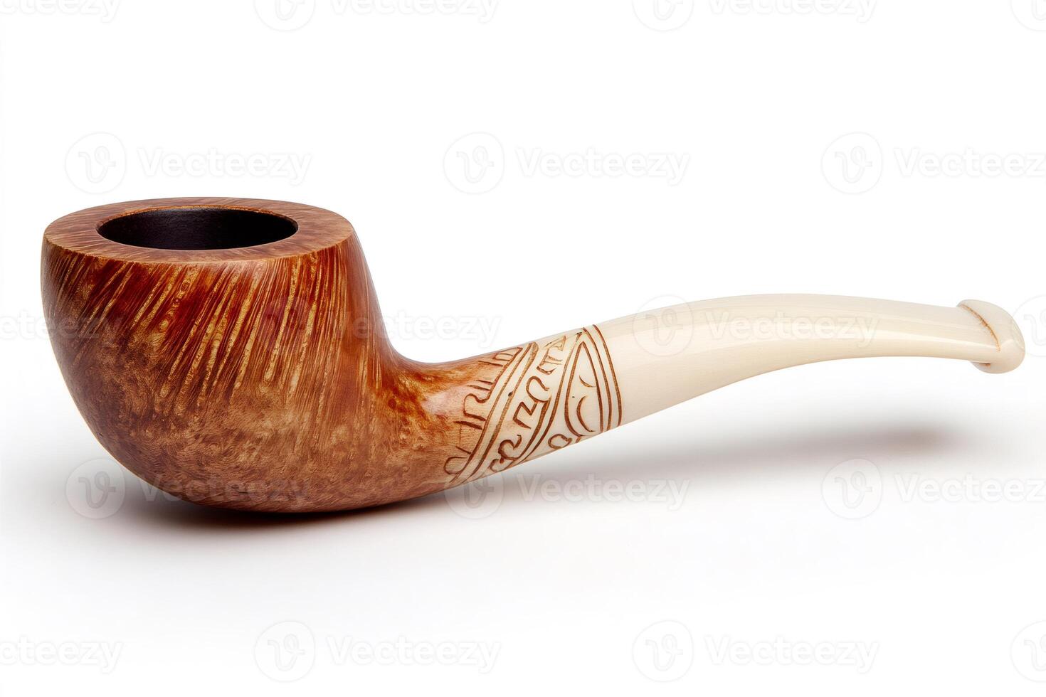 Elegant carved briar pipe with ivory stem resting on white background photo